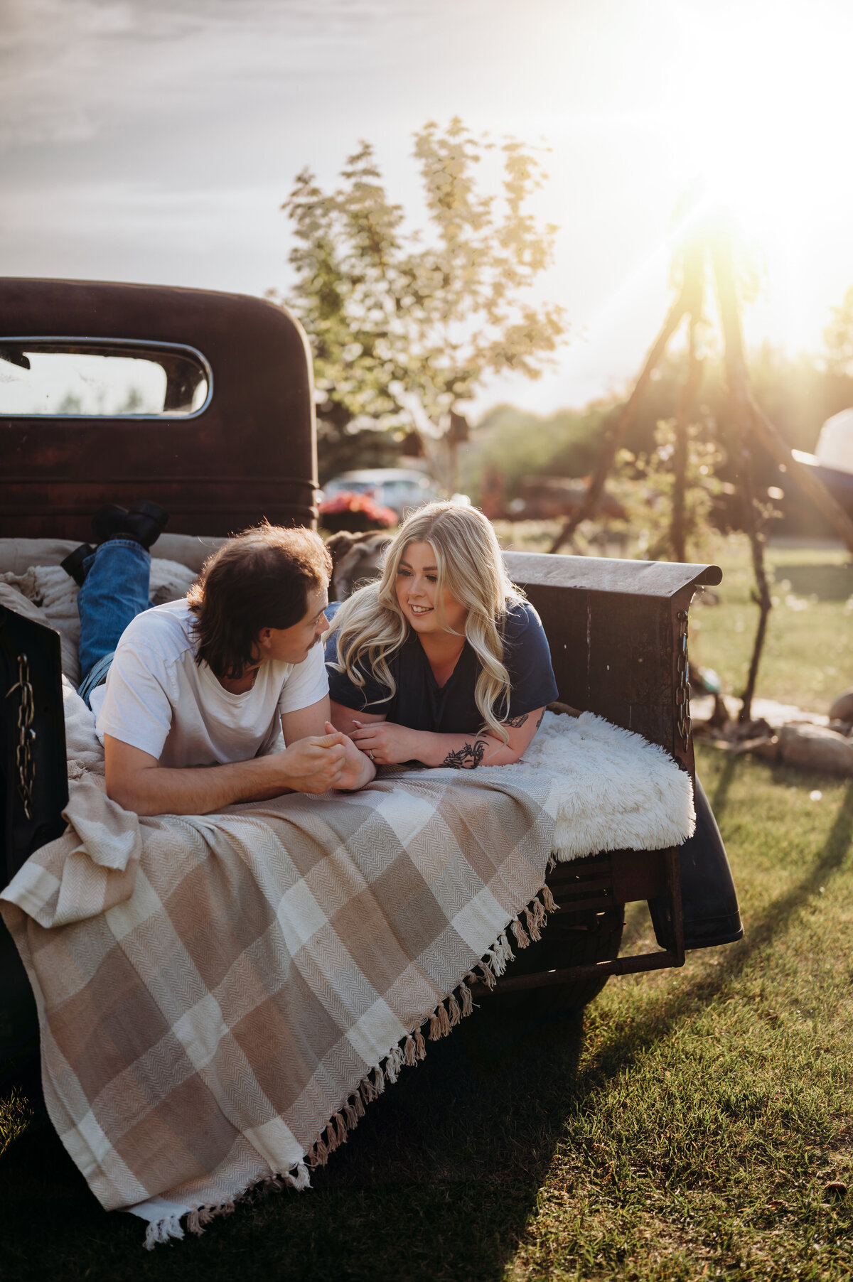 edmonton couple looking at each other and smiling for engagement photos