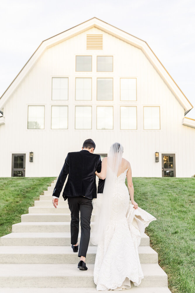 bride and groom walking up stairs at wedding venue
