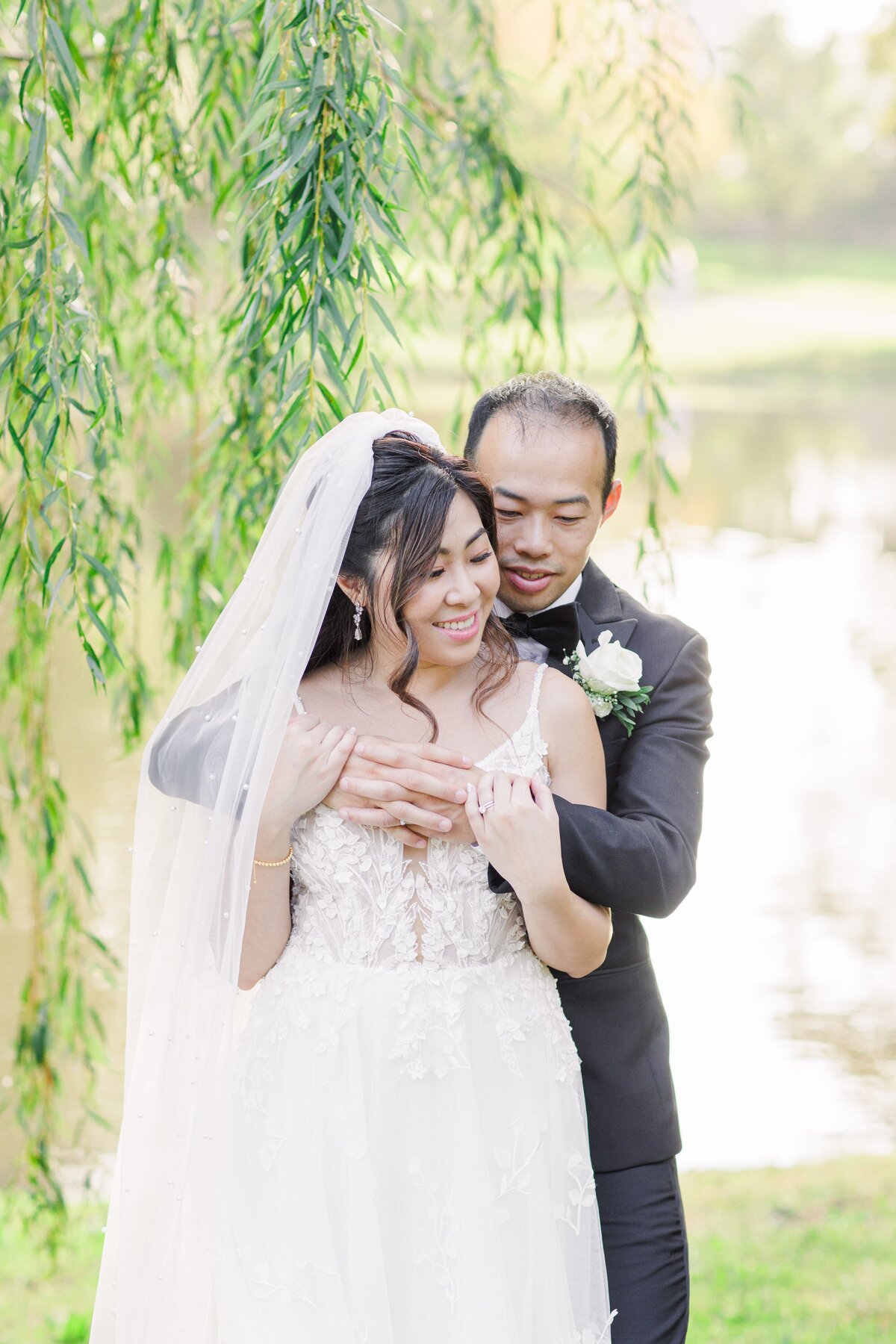 Bride and groom smiling and hugging during their Boston wedding portraits