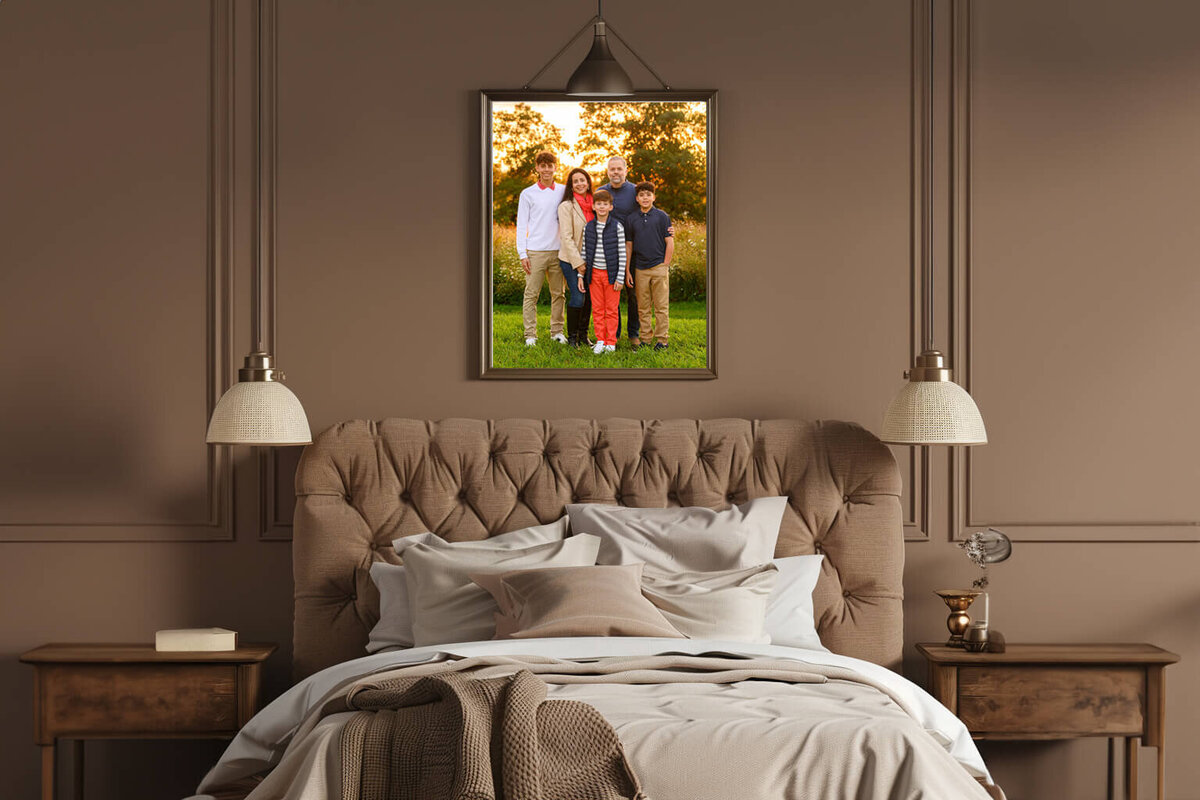 Brown bedroom with a framed photo of a family at their sunset golden hour Burlington family photography session