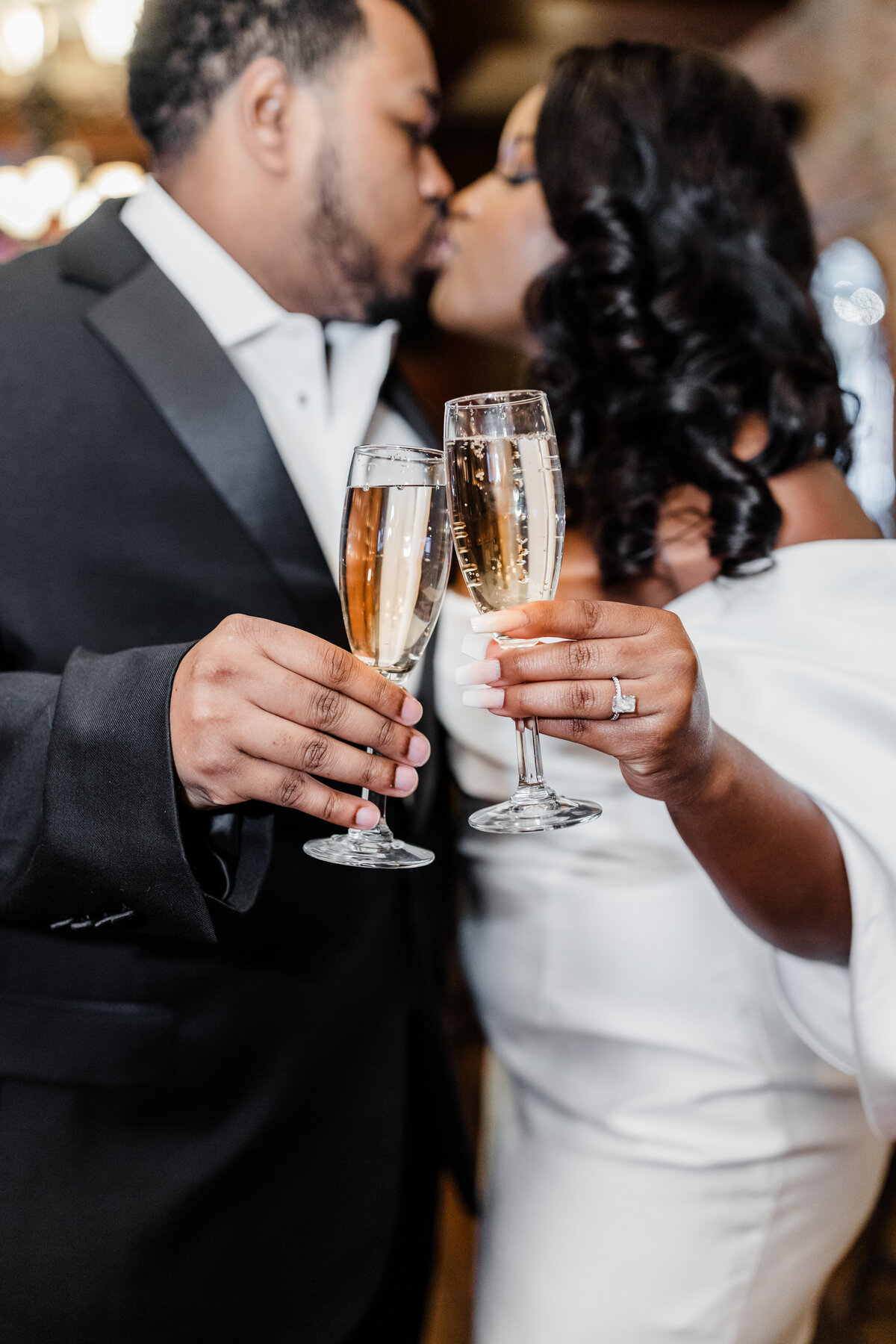 Couple toasting with champagne glasses during their wedding reception in South Bend, Indiana.