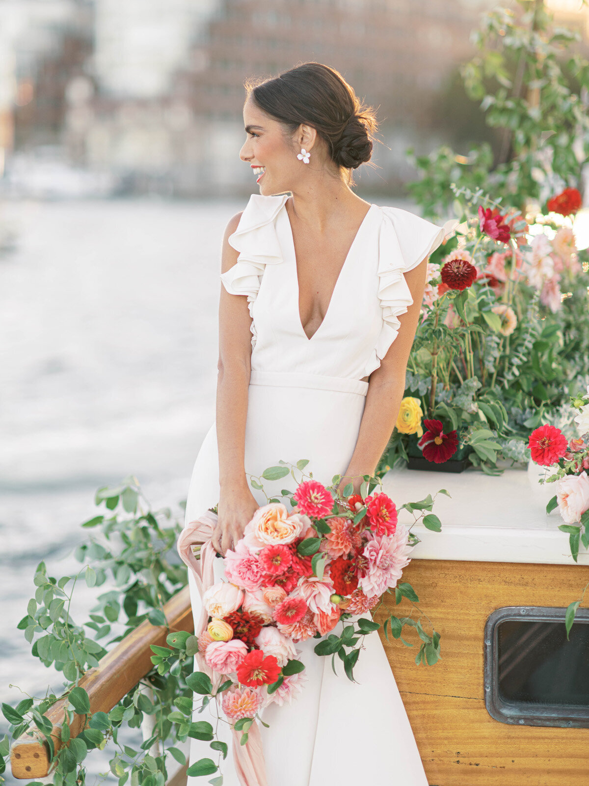 Kate-Murtaugh-Events-elopement-wedding-planner-Boston-Harbor-sailing-sail-boat-yacht-greenery-water-skyline-couple-bouquet-smiling-bride