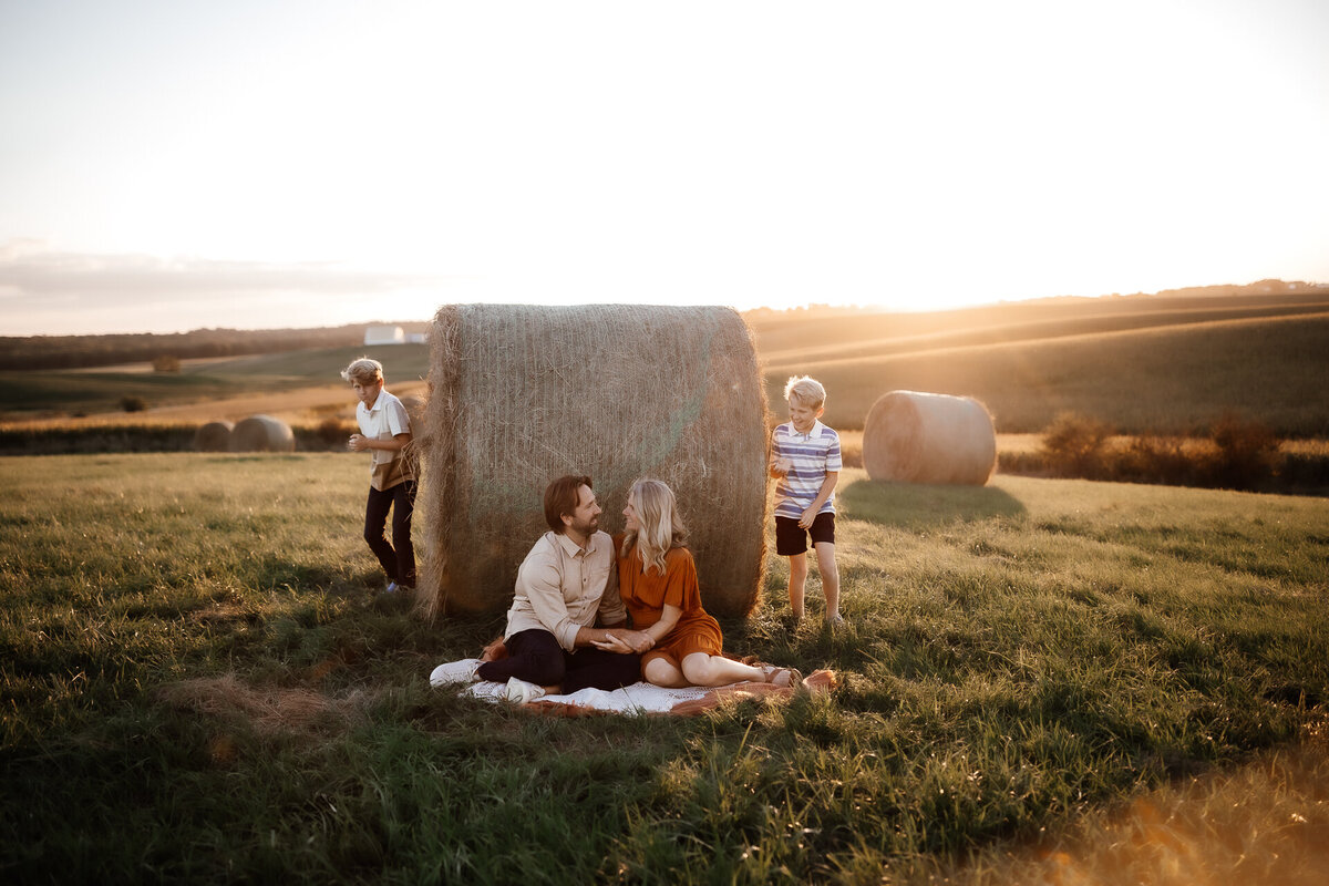 family photos by hay bale in iowa