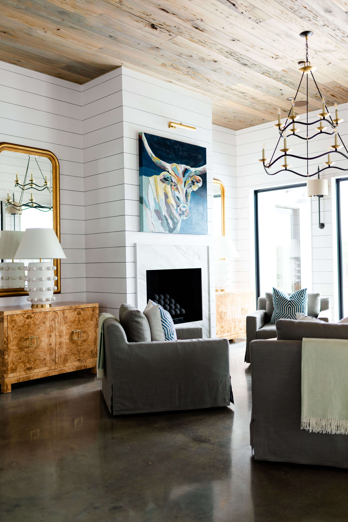 oyster creek studios building belt new build yak painting and wooden side table in living room with gray seaitng