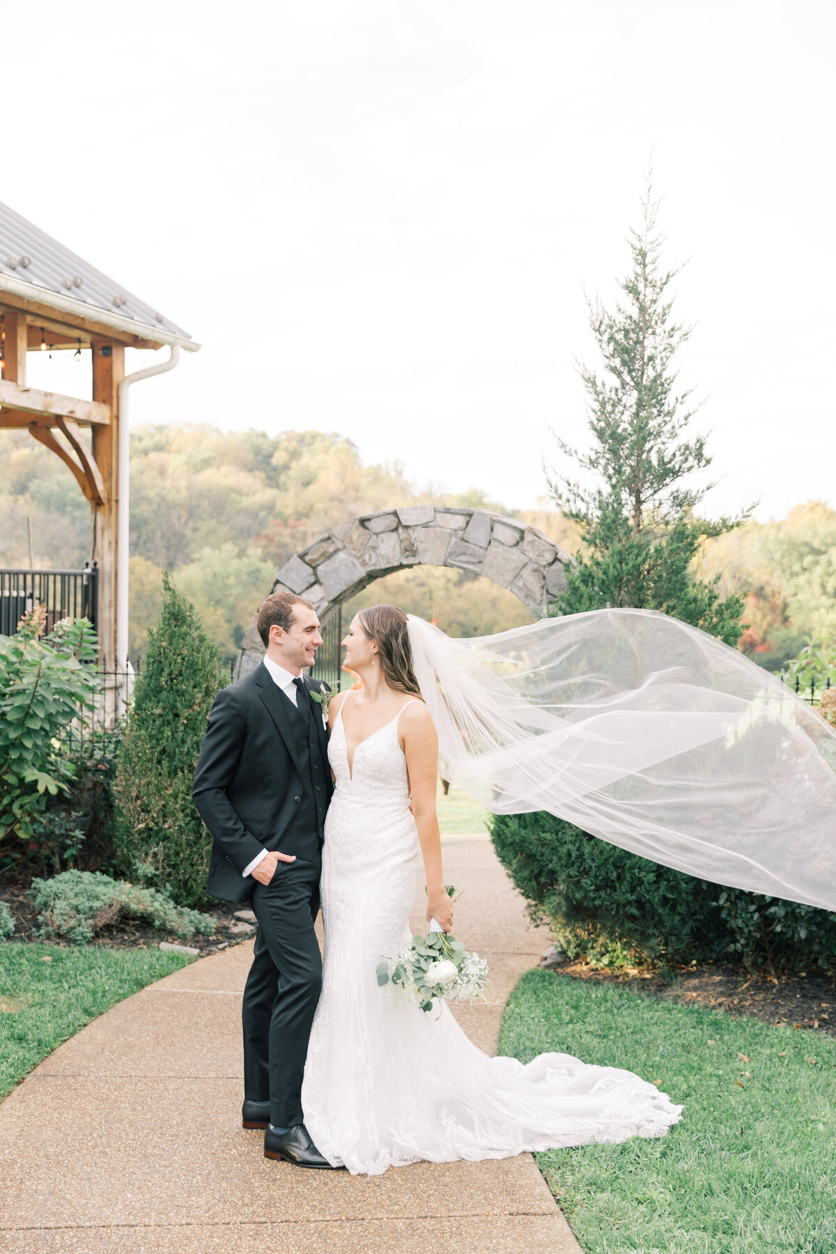 Virginia winery wedding portrait of bride with veil blowing in the wind, capturing a magical moment.