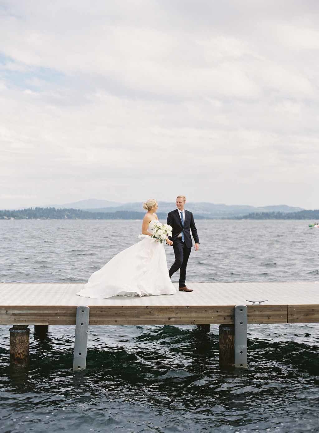 bride and groom walking along dock at Lake Washington