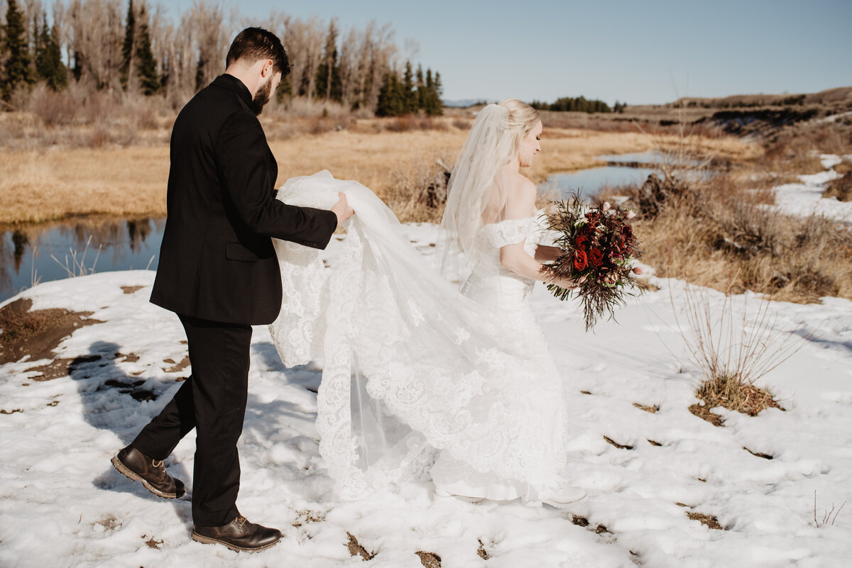 Jackson Hole Photographers capture bride walking with groom holding train