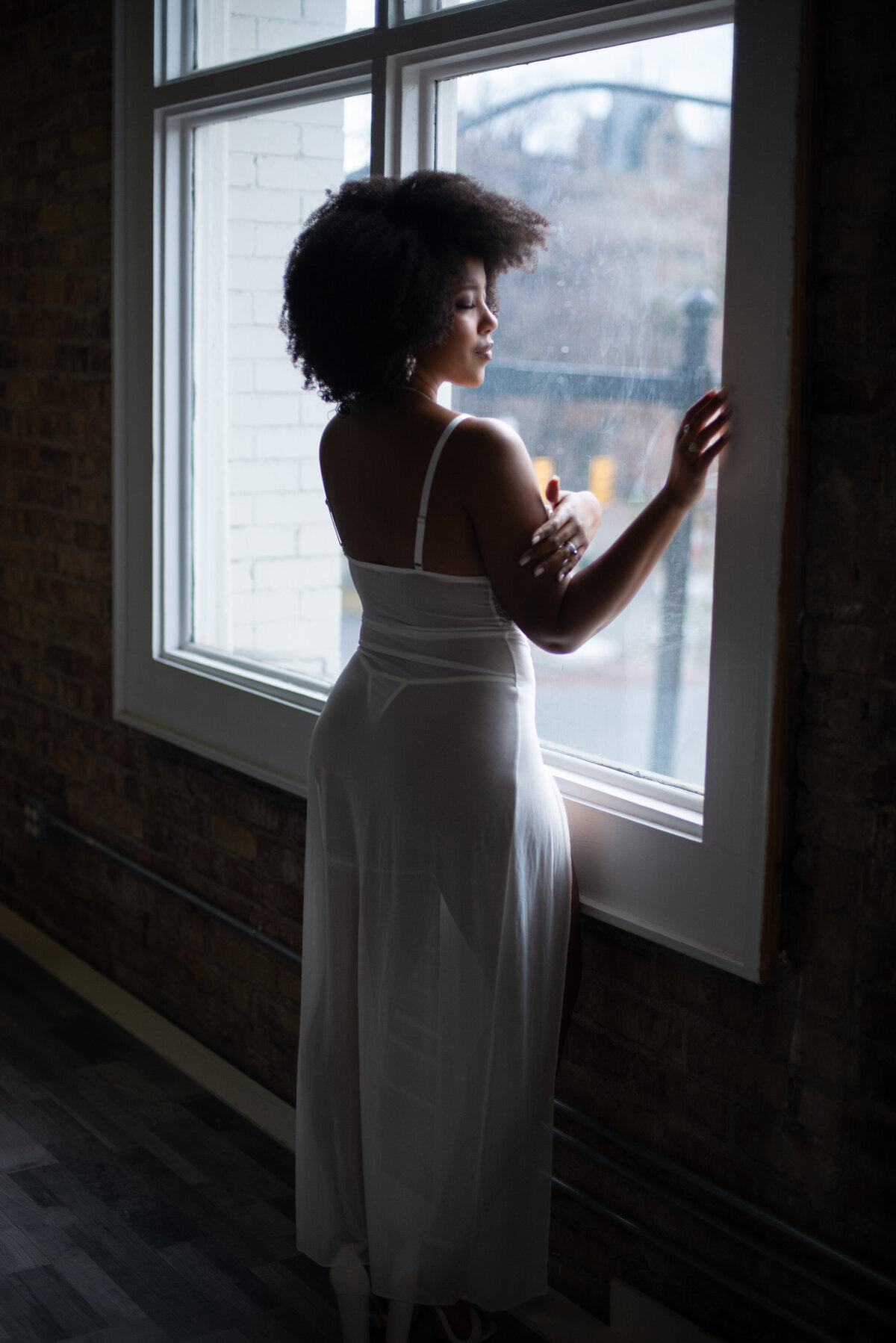 Empowering boudoir image of a woman embracing her body confidently