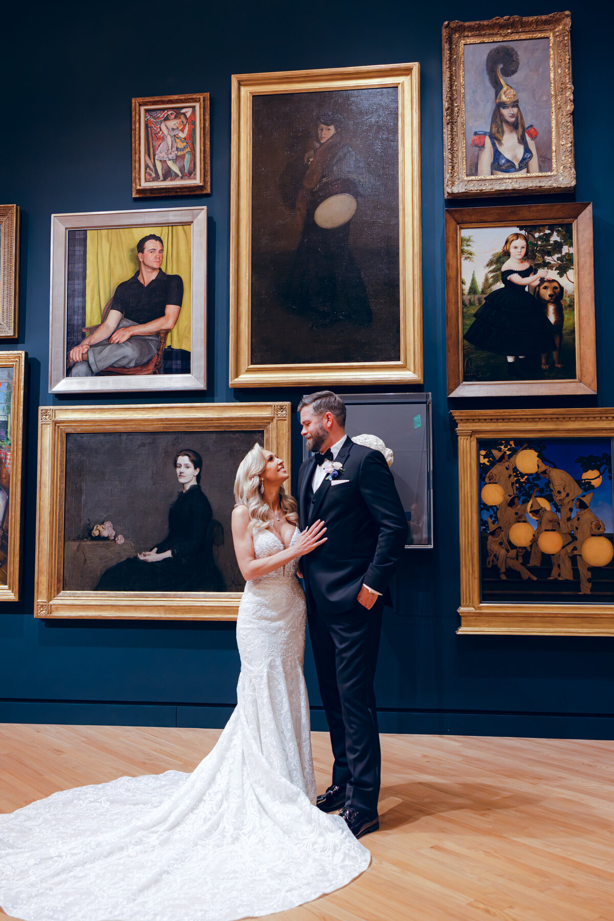 A wedding day photo  of the bride and groom posing for a portrait in Crystal Bridges Museum of American Art in Arkansas