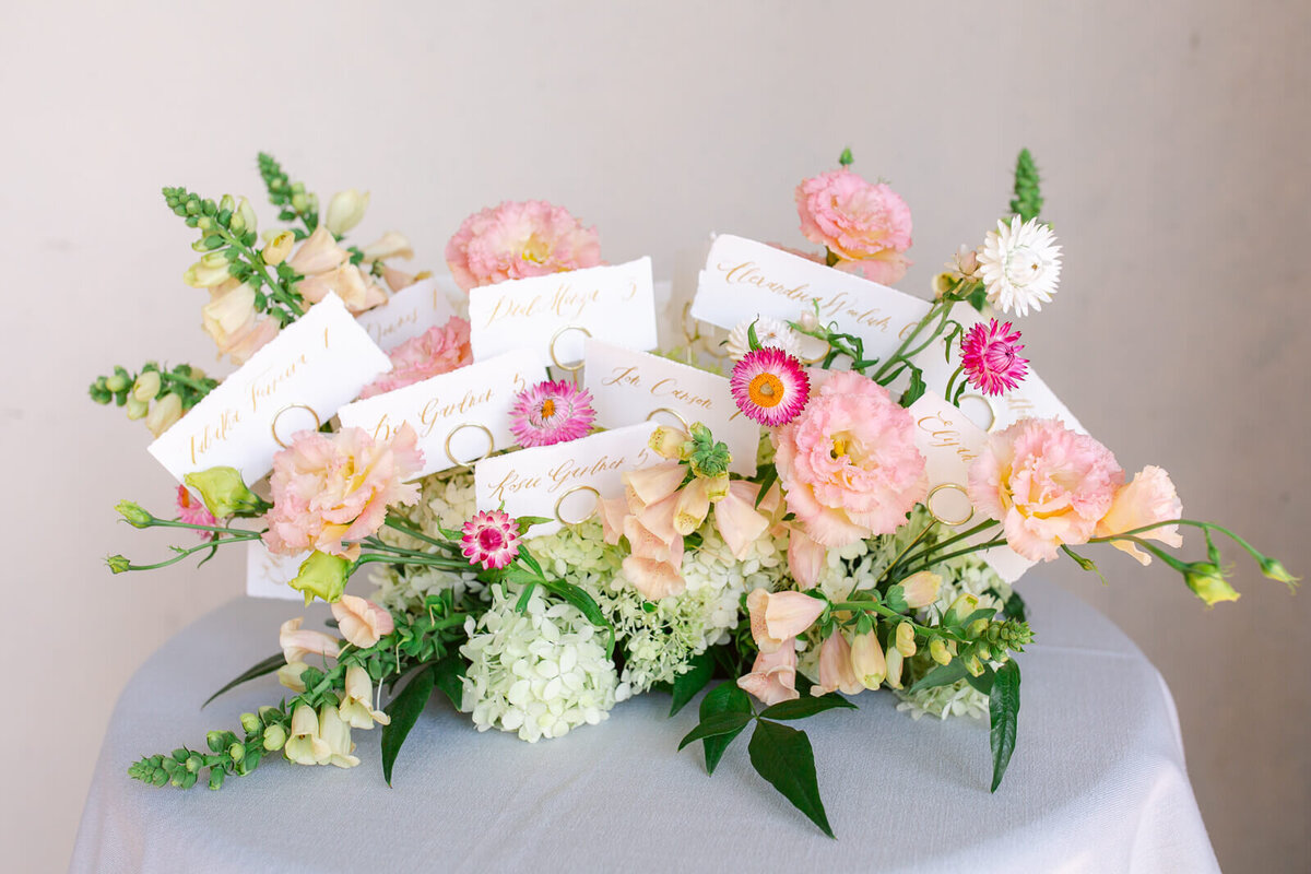 Name cards and floral arrangement for wedding at Great Marsh Estate.