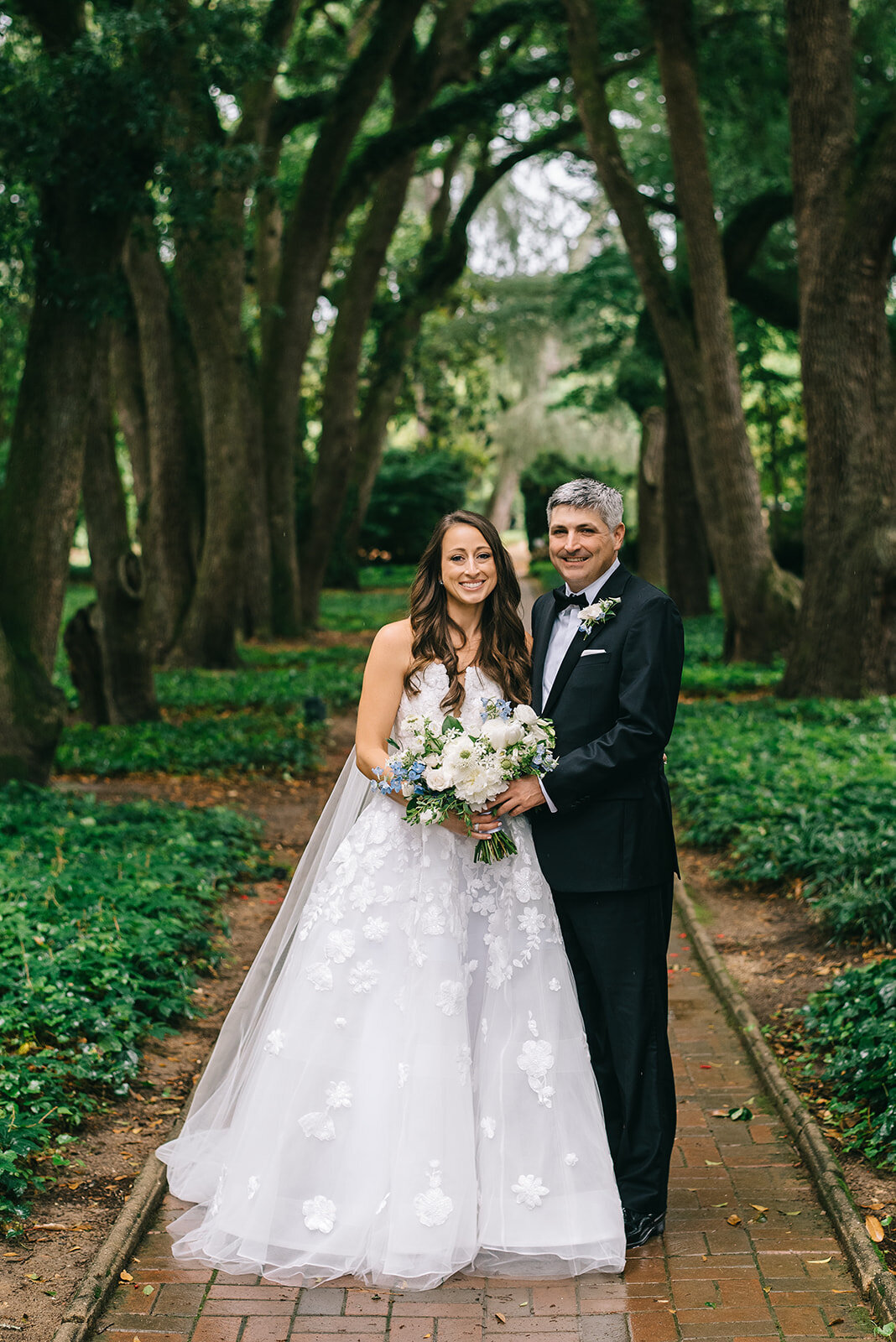 Bride and groom with white and blue bouquet designed by Abby Grace Florals at Greenville SC wedding