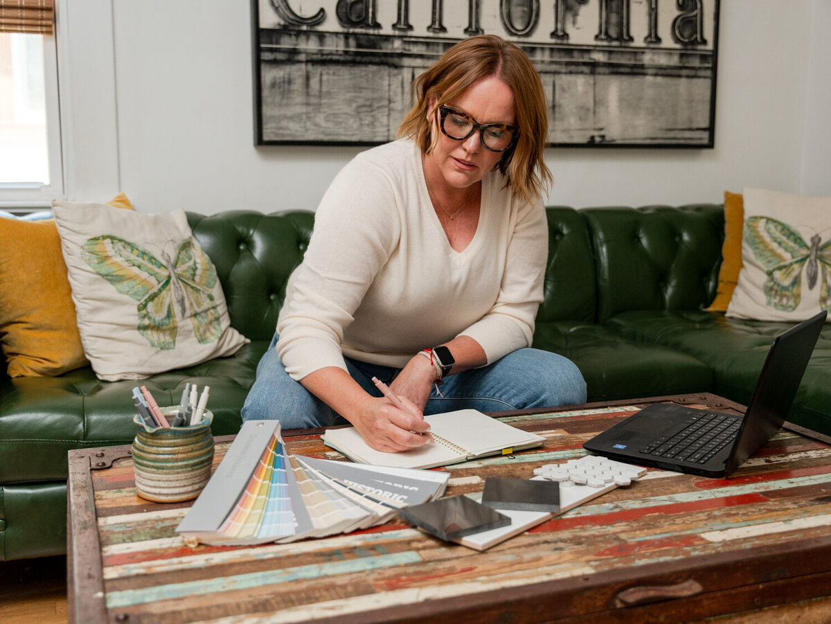 Construction project manager at home with different building finishes layed out on her coffee table