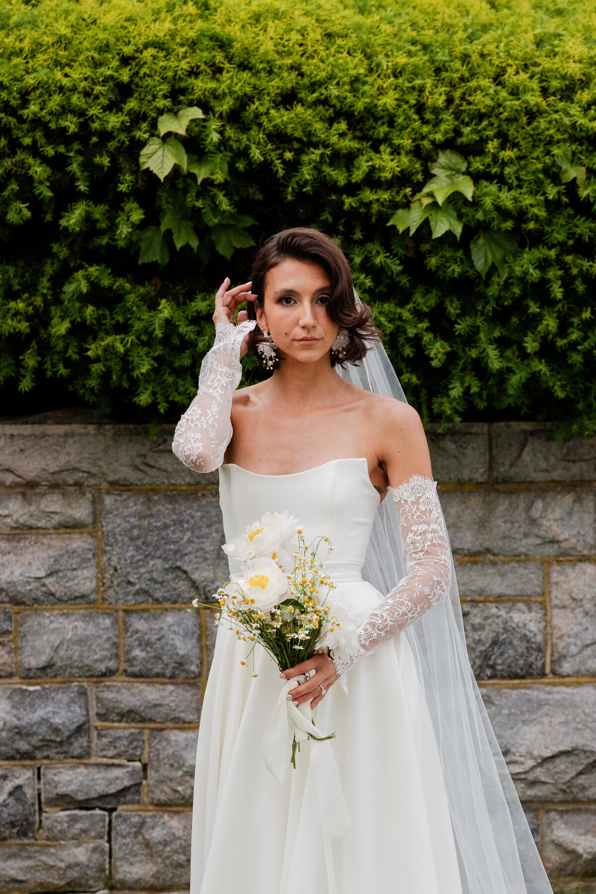 A photograph of a bride fixing her hair.