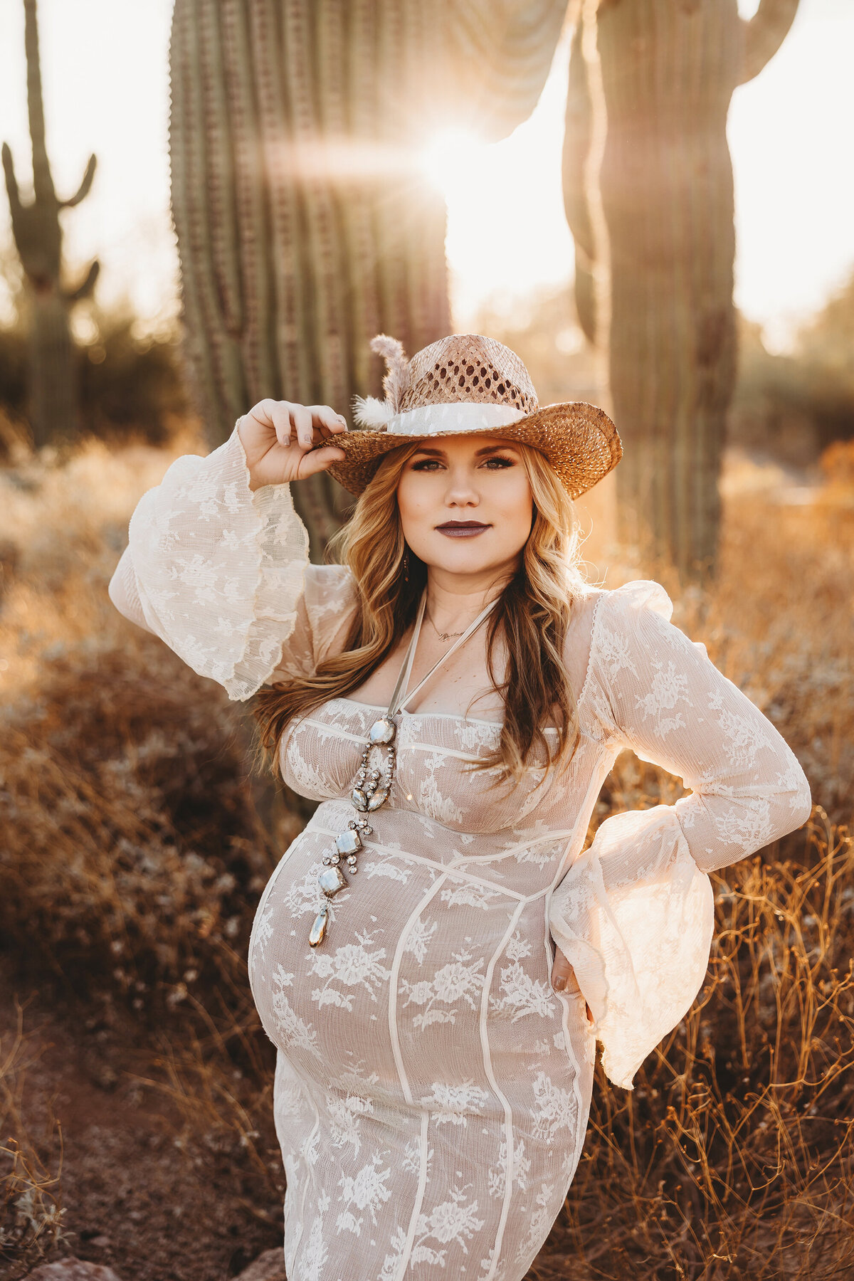 Pregnant mother in lace dress posing for maternity session in arizona