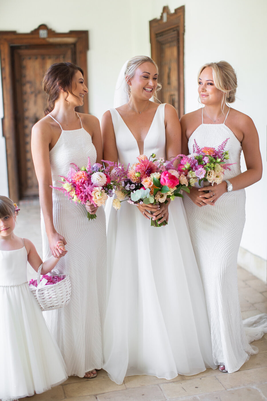 Colourful bridesmaid bouquets against white bridesmaid dresses