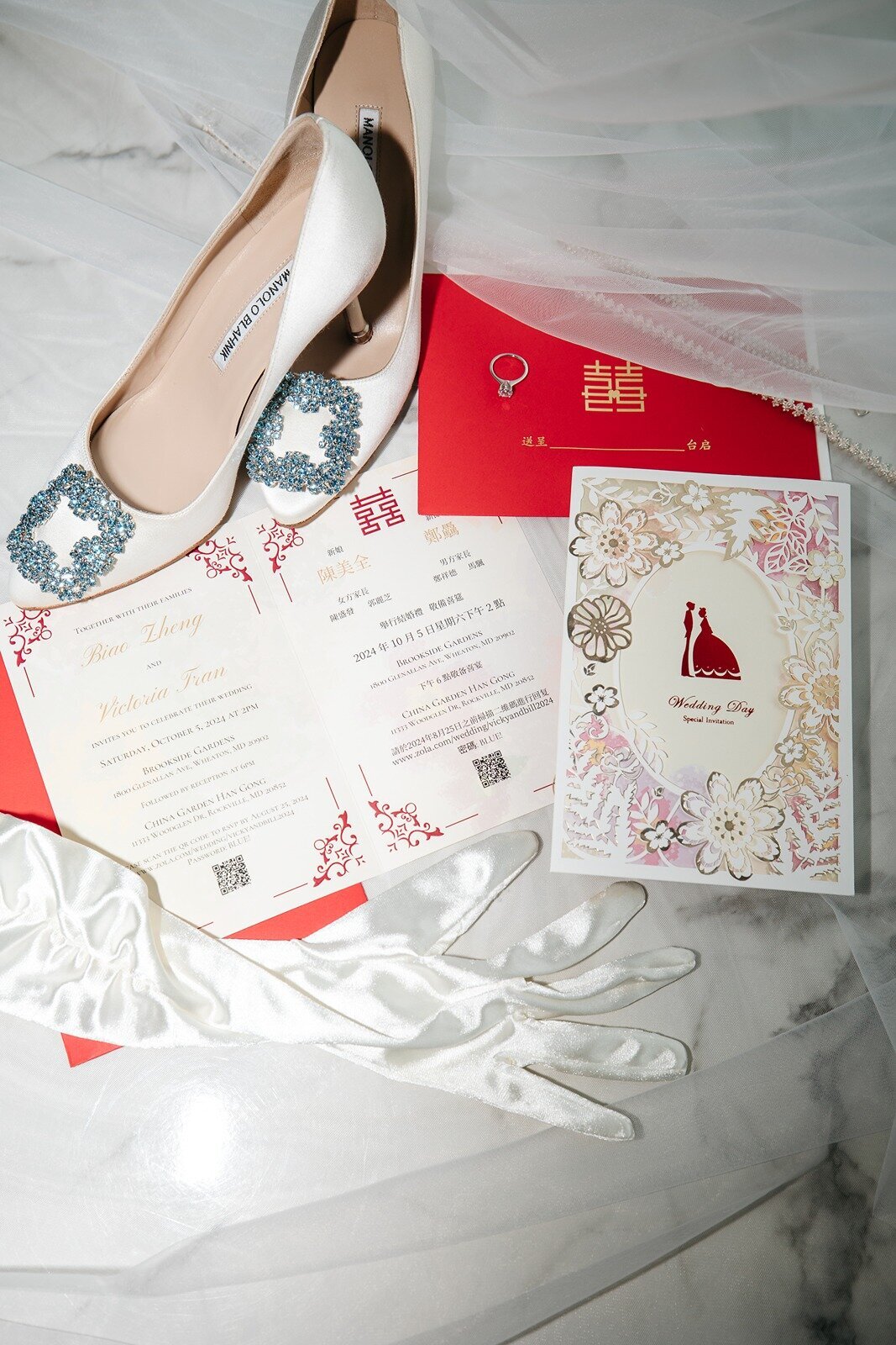 Flat lay of wedding invitation, wedding shoes, and brides gloves