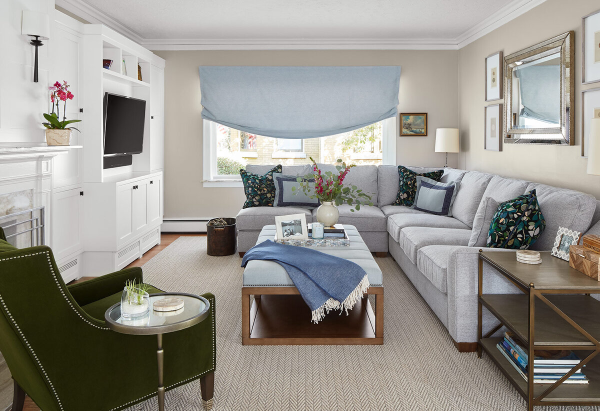 Living room with grey couch and light blue accents and an olive green chair