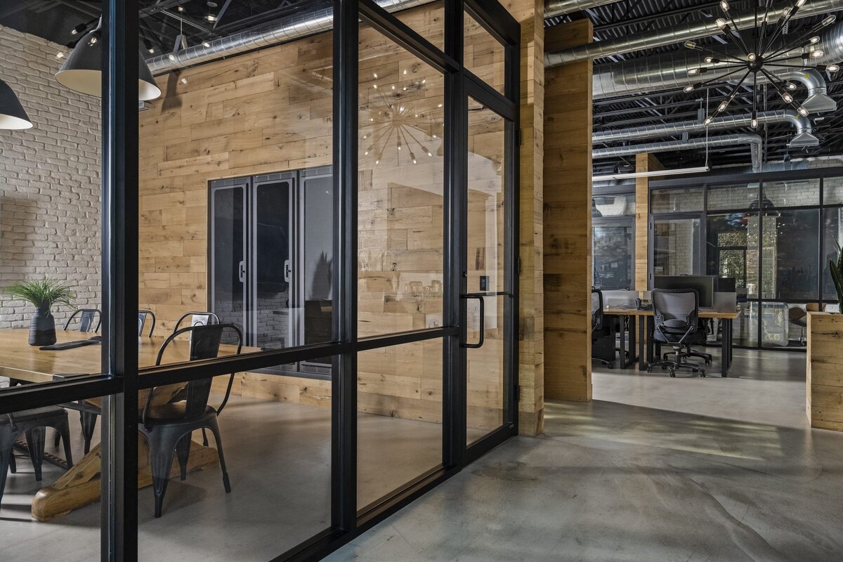candra lynn interiors old bridge project large hall with black trimmed glass window into conference room