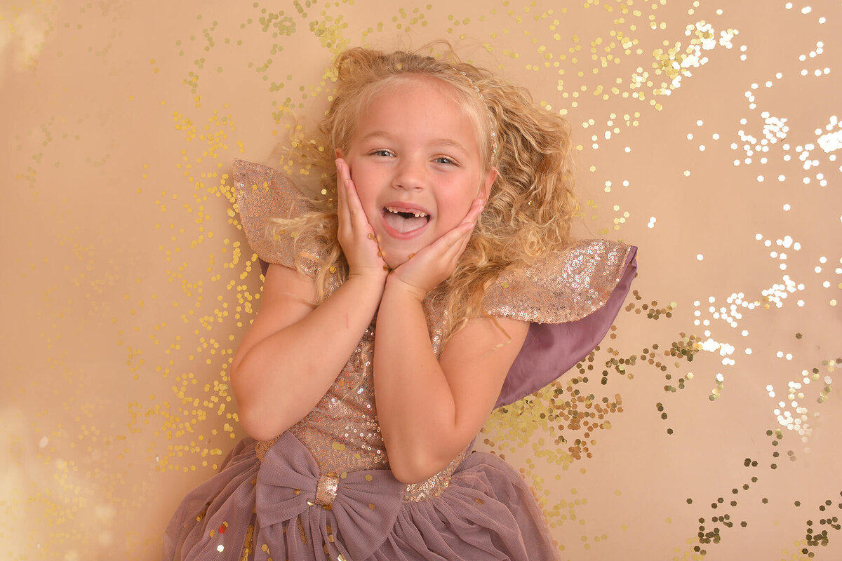 girl smiles at the camera at her glitter birthday photoshoot in houston