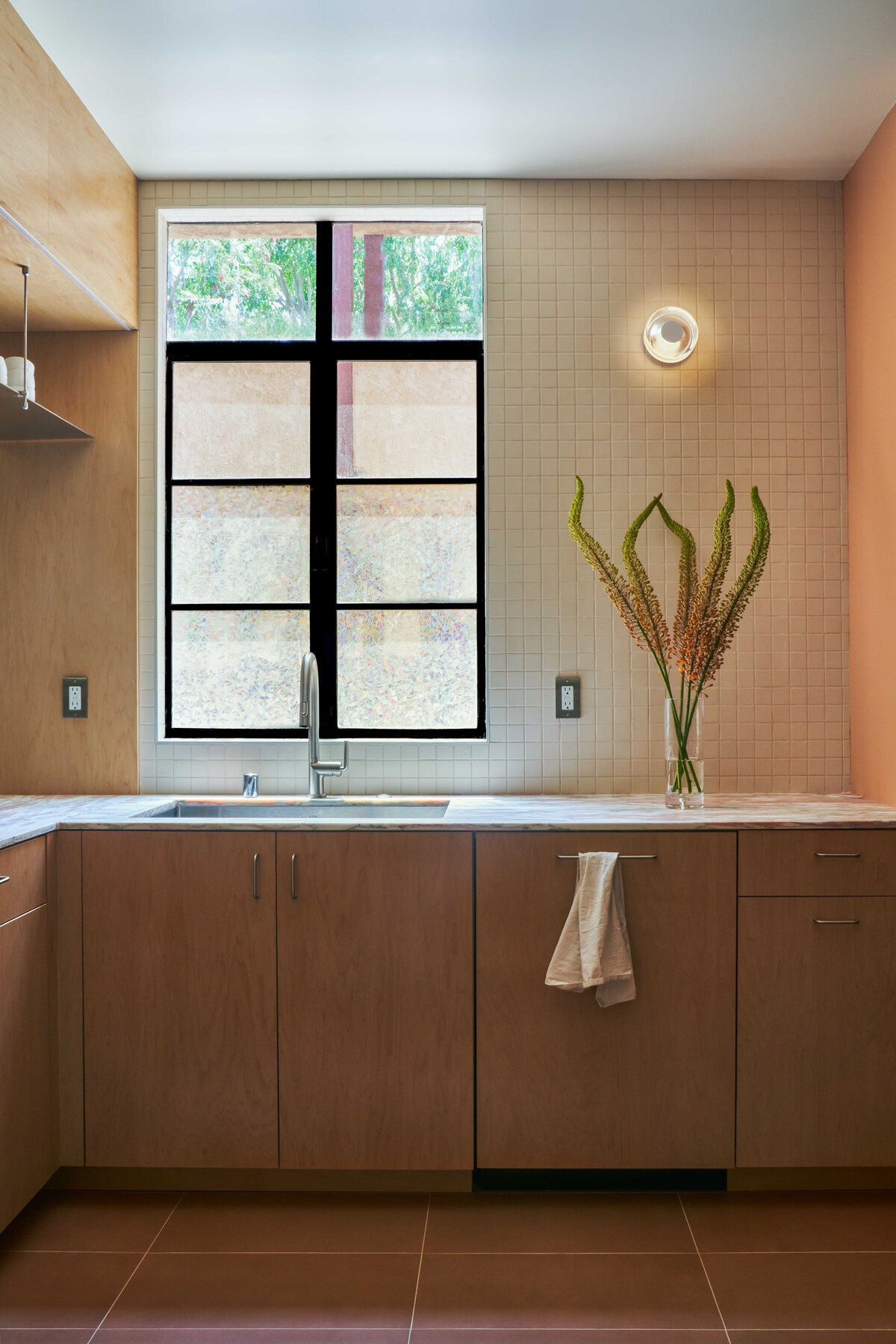 Southern California kitchen remodel galley kitchen renovation modern organic kitchen design Norwegian Rose marble countertop maple plywood kitchen cabinets stainless steel floating shelf porcelain 2x2 mosaic tile Saltillo breeze blocks modern kitchen storage solutions SoCal interior design organic modern kitchen kitchen design with natural light thoughtful floor plan edits custom pullout pantry contemporary galley kitchen