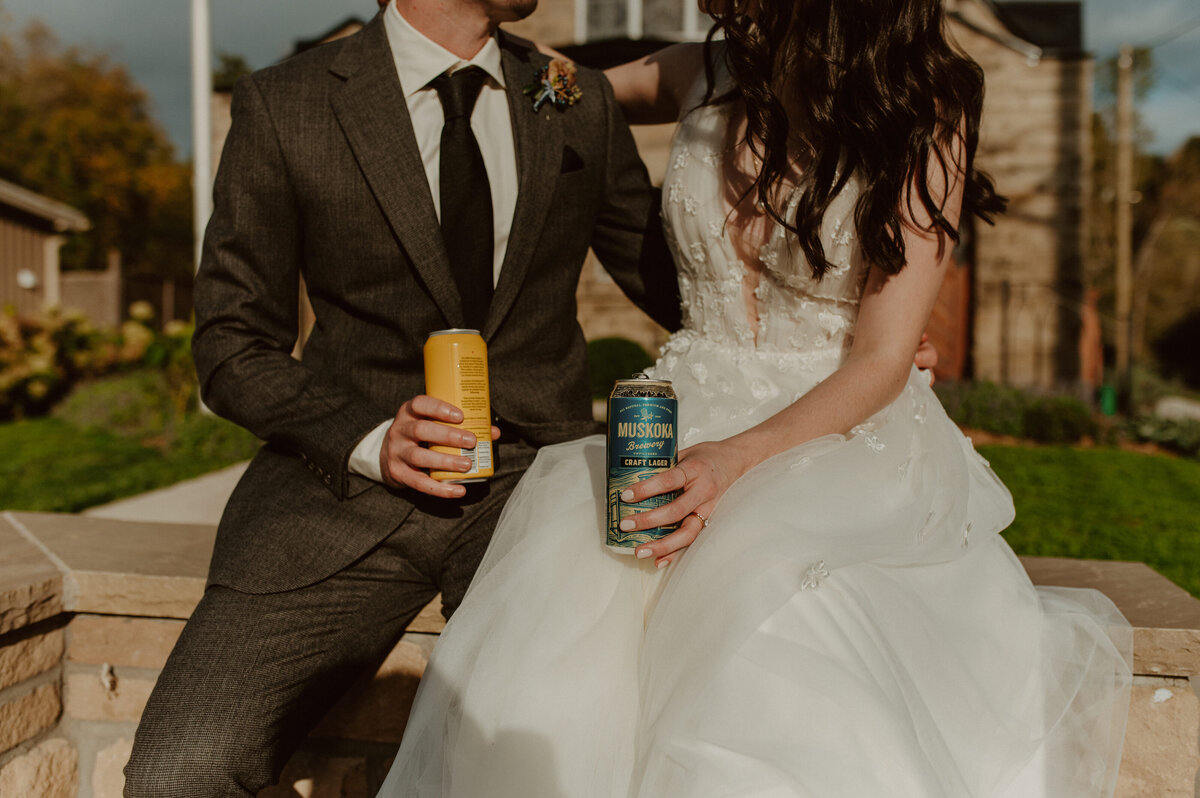 couple sharing beers after wedding ceremony in ontario