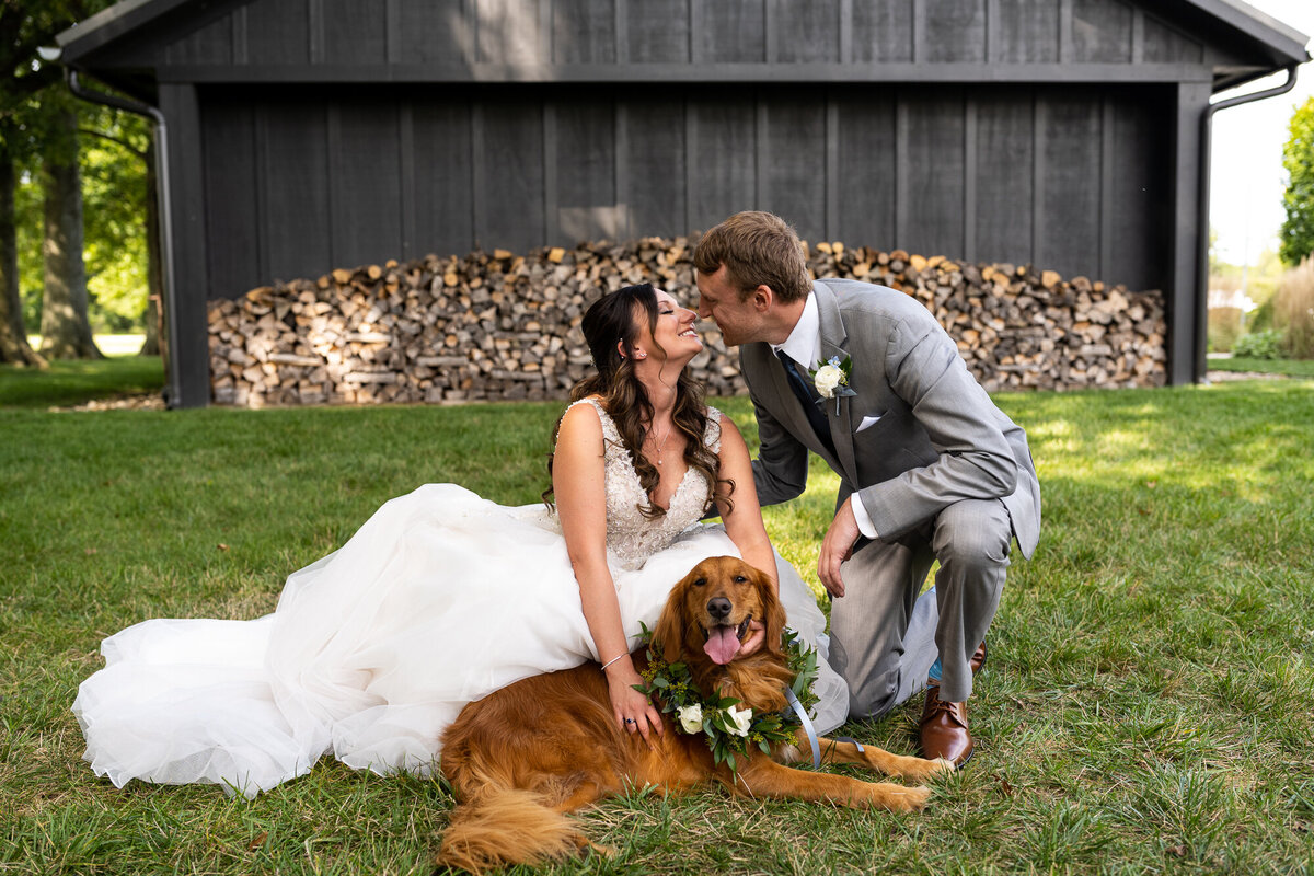 Bride and groom pose with their dog the flower girl