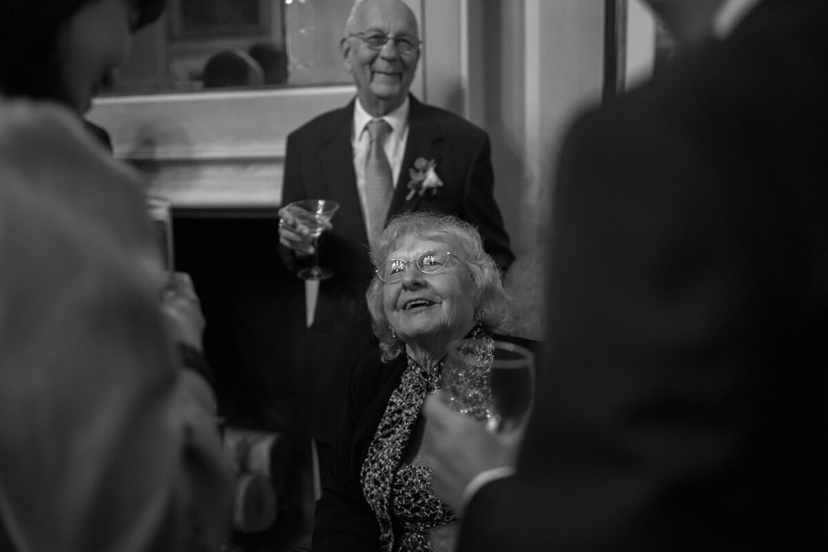 Grandmother smiles during cocktail hour at Crane Estate.