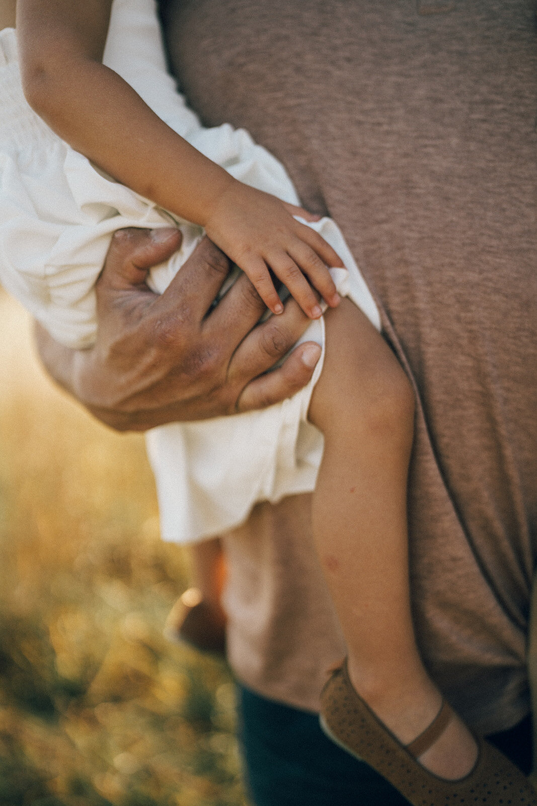Close-up of father holding his young child close during a candid lifestyle family photo session