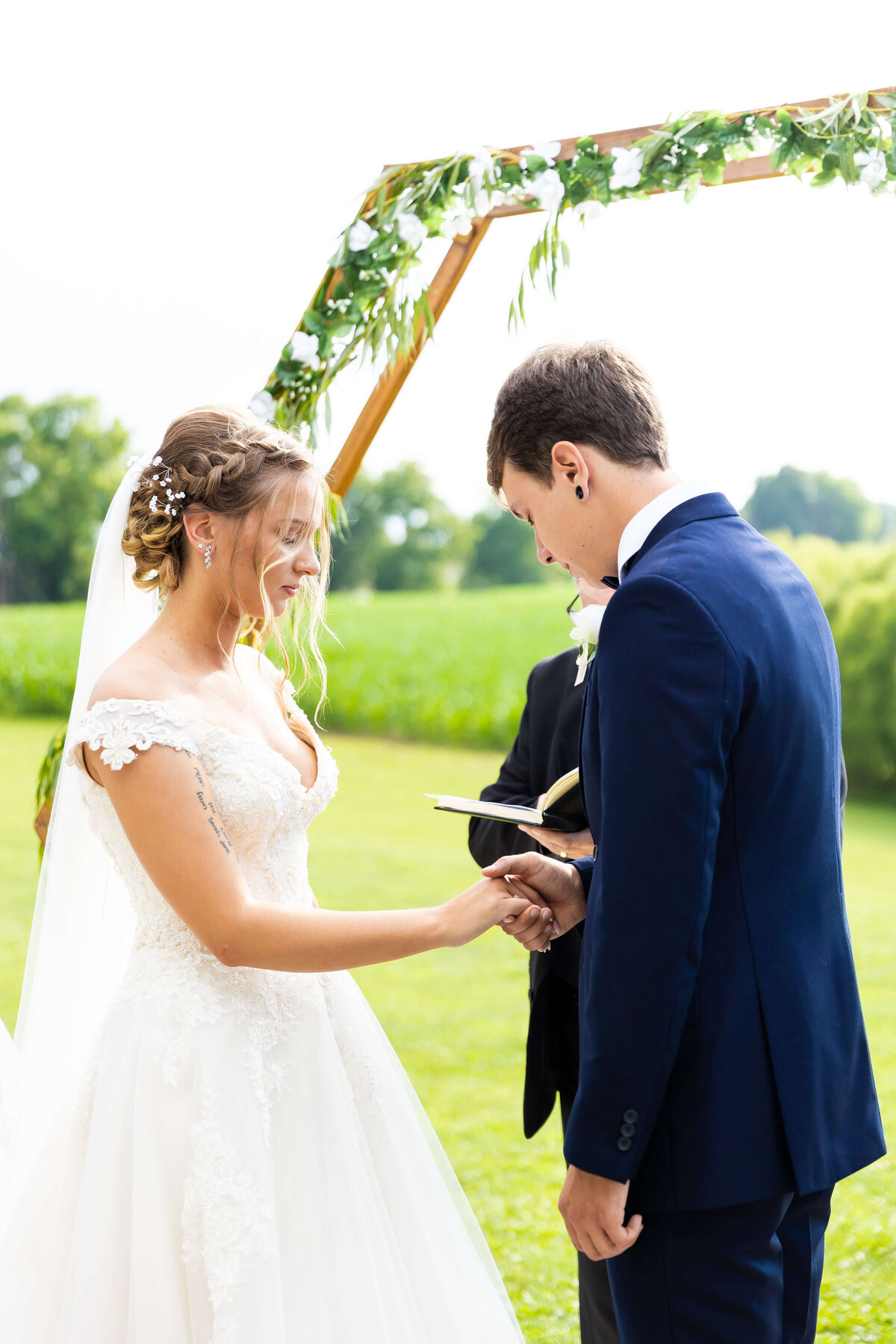 Bride and groom exchanging vows at Ruby Cora wedding venue in Adams,,TN