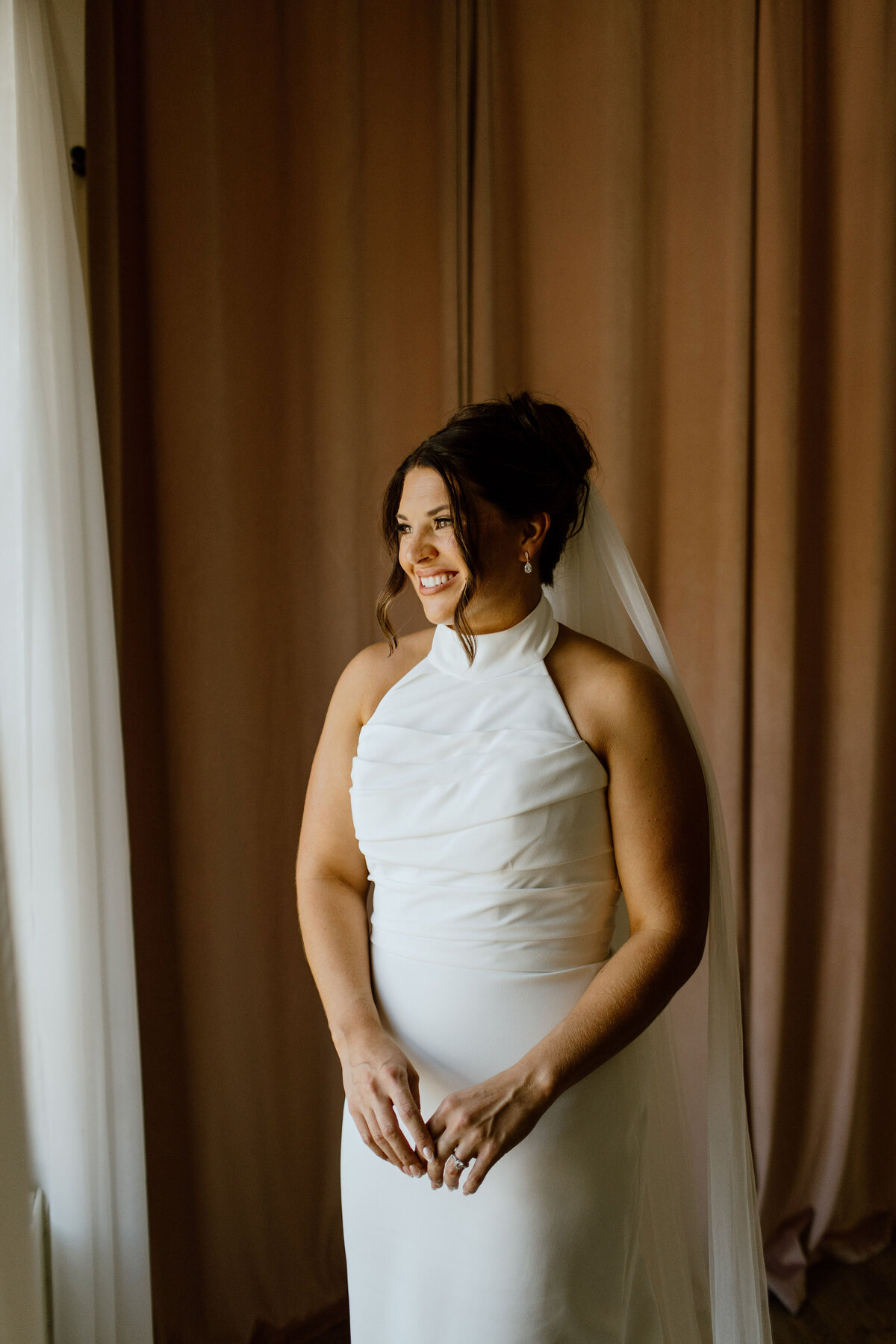 Bride in elegant gown with classic wedding hair and makeup in Rockford, IL.