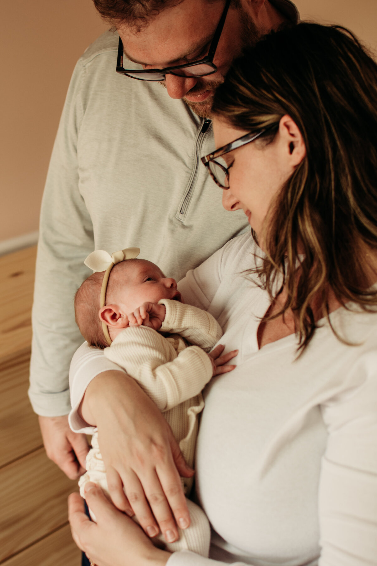 Mom and dad admiring their newborn baby girl during a photoshoot in Bartlett, IL