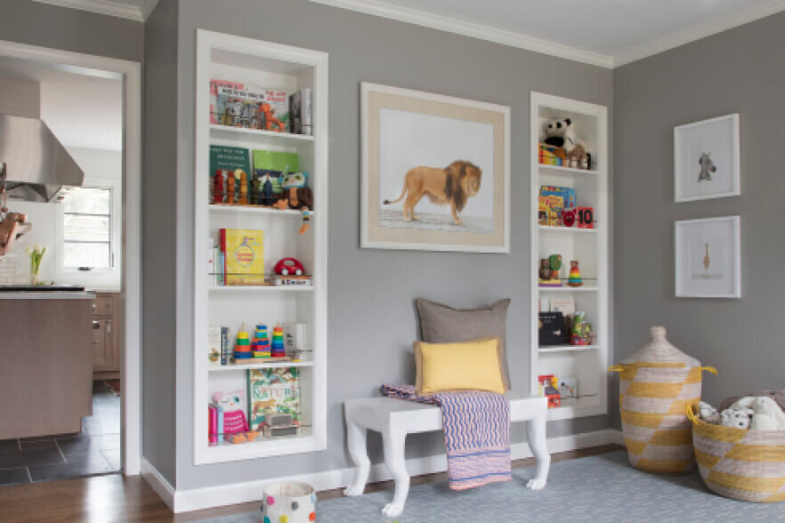 Interior decorators in Westwood, MA design a playroom with custom shelves, designed for toy storage now and to transition into a formal dining room later.
