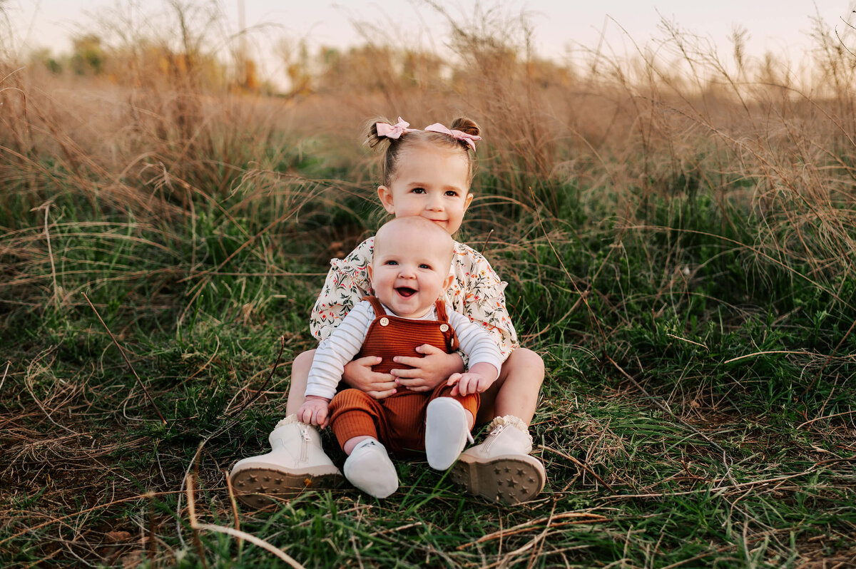 Springfield MO family photographer captures siblings smiling in field
