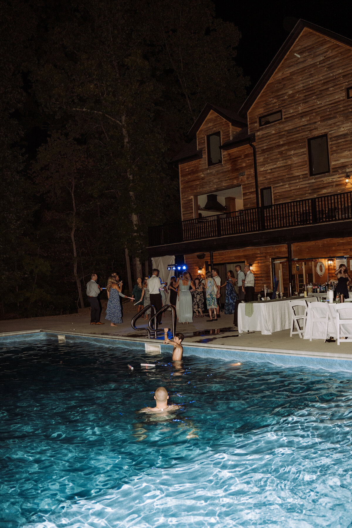 wedding guests enjoying the pool at reception