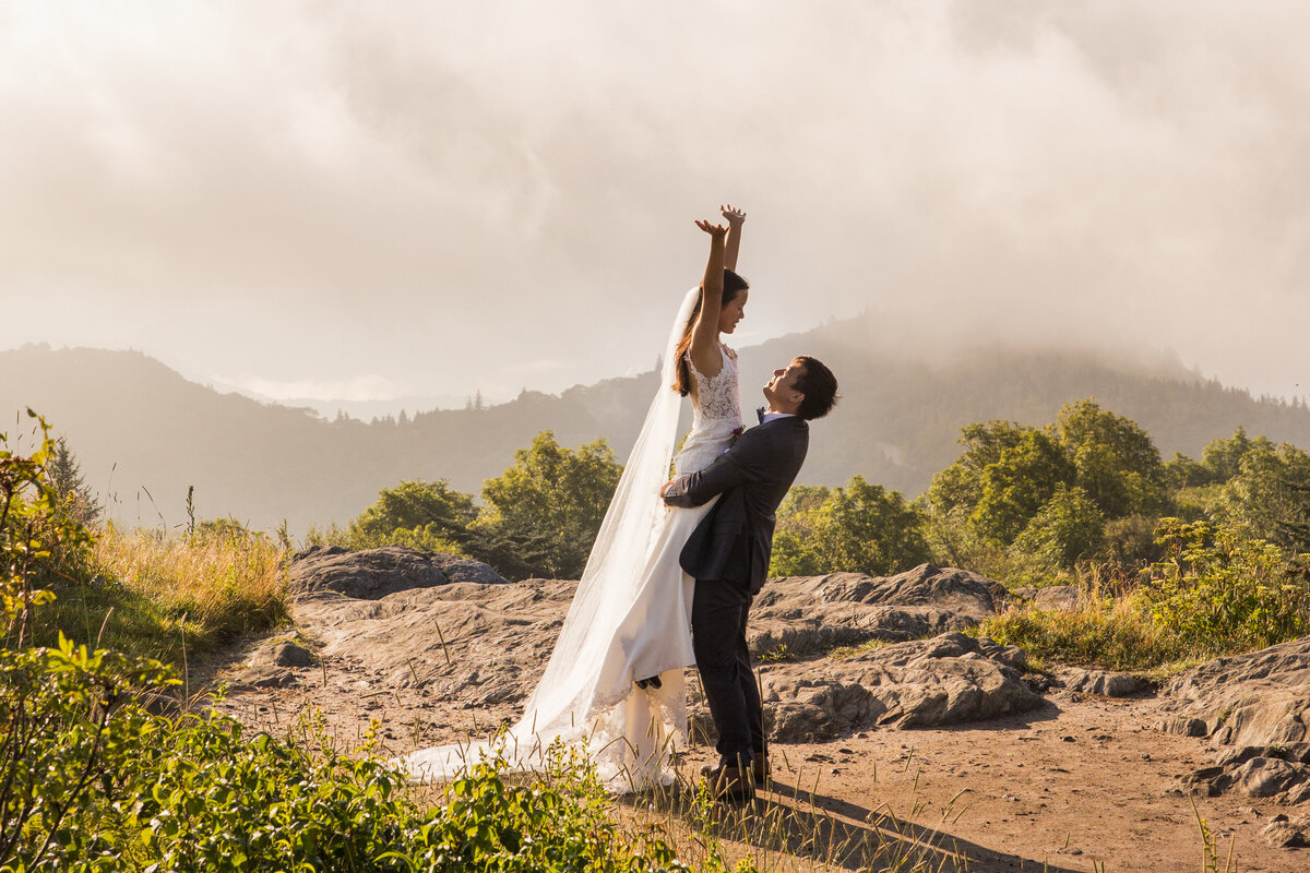 couple shares a dance on a mountaintop with an epic view at black balsam knob in nc