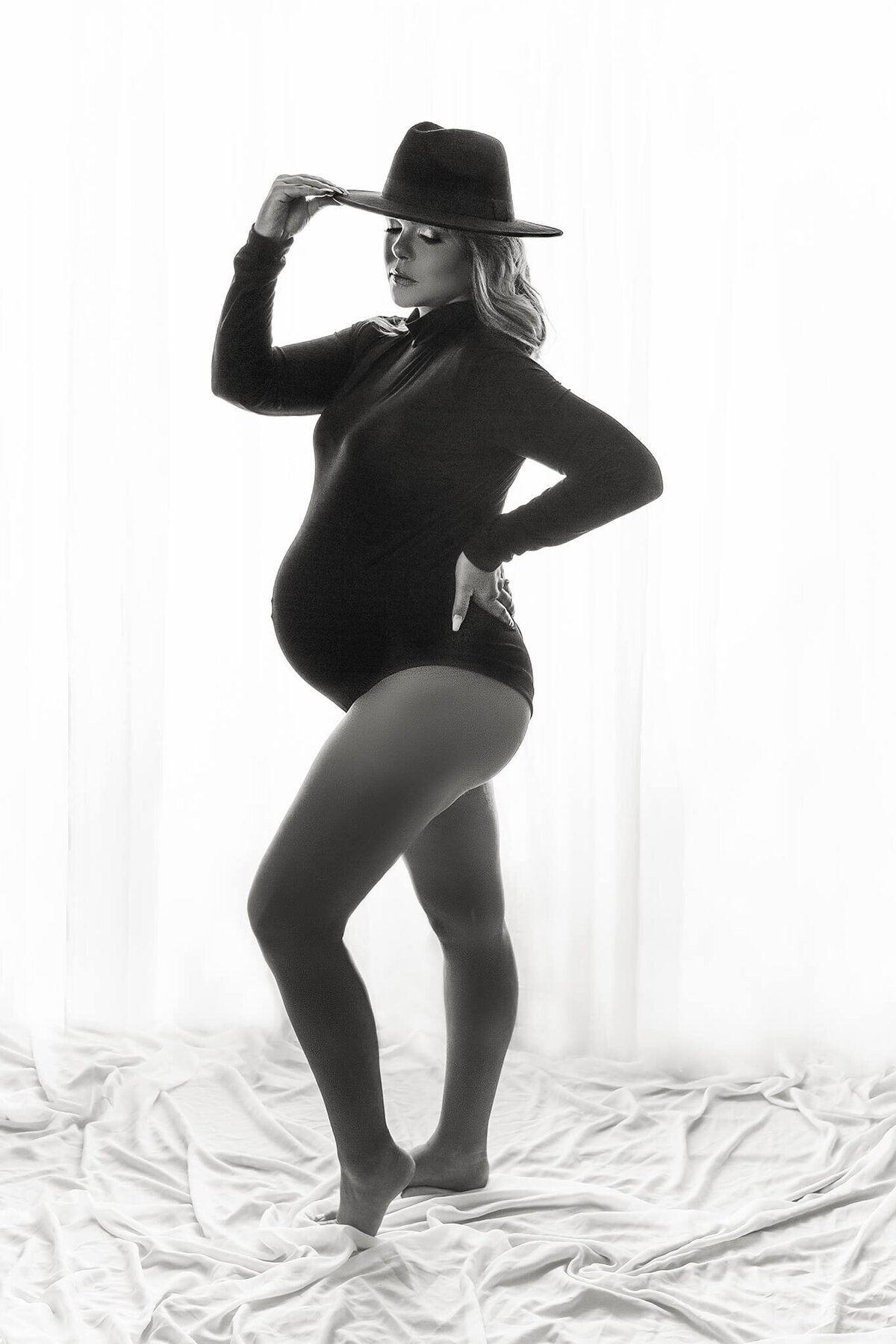 pregnant mom wearing bodysuit and wide brimmed hat poses for black and white maternity portraits, Hamilton