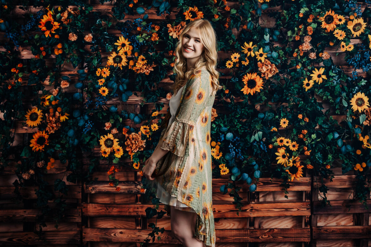 Girl poses in sunflower dress in session with Prescott senior photographer Melissa Byrne