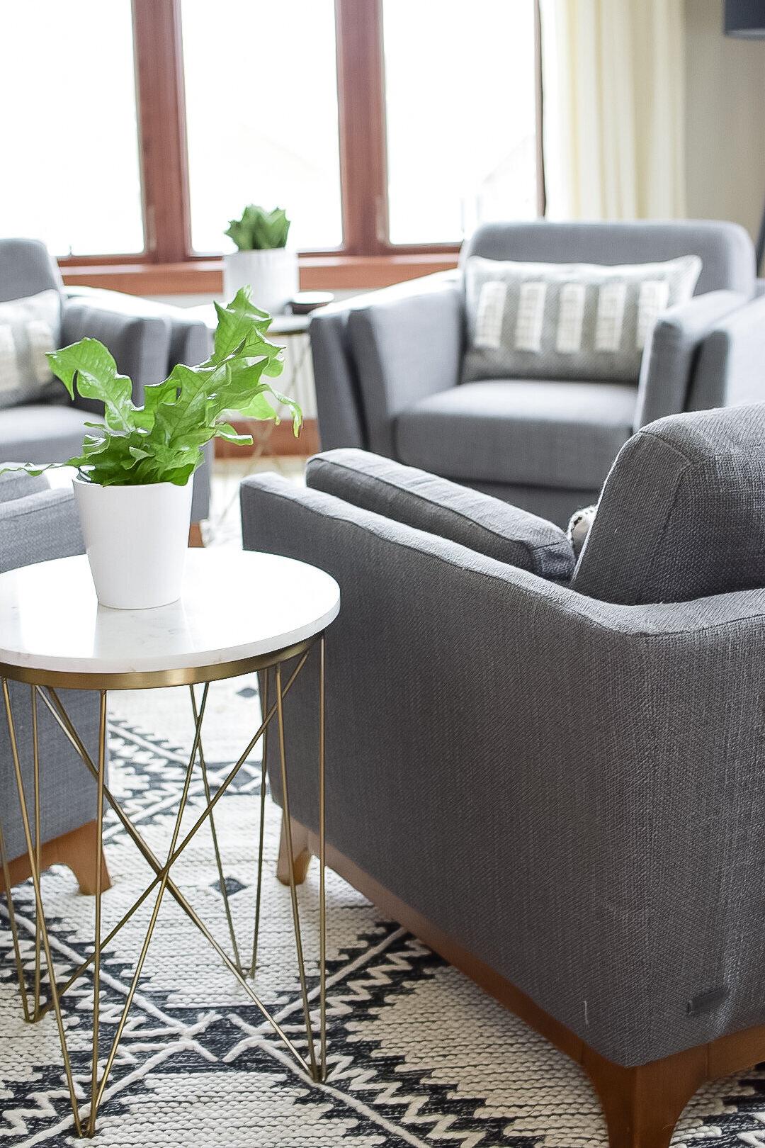 A modern grey armchair in a home seating area