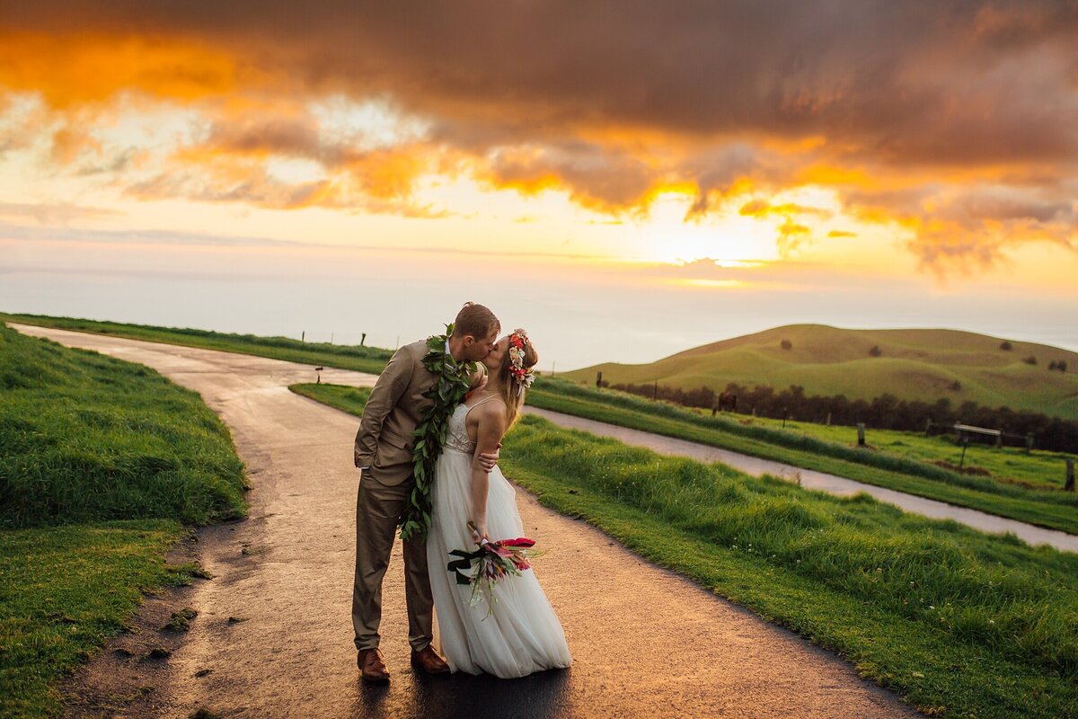 wedding couple kissing at sunset