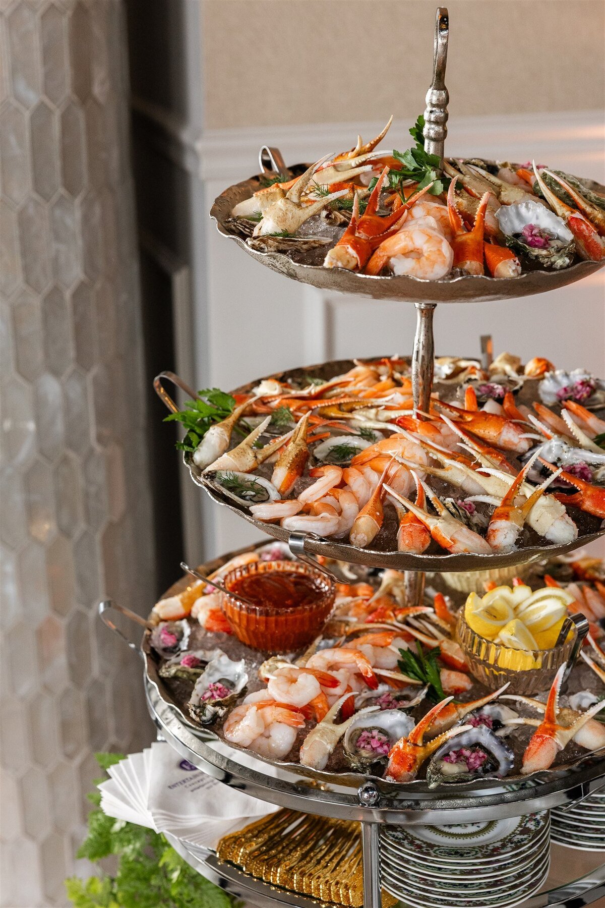 Venue space set up as an endive station, with neatly arranged endive leaves filled with gourmet toppings on elegant platters, displayed on a styled table with decorative accents