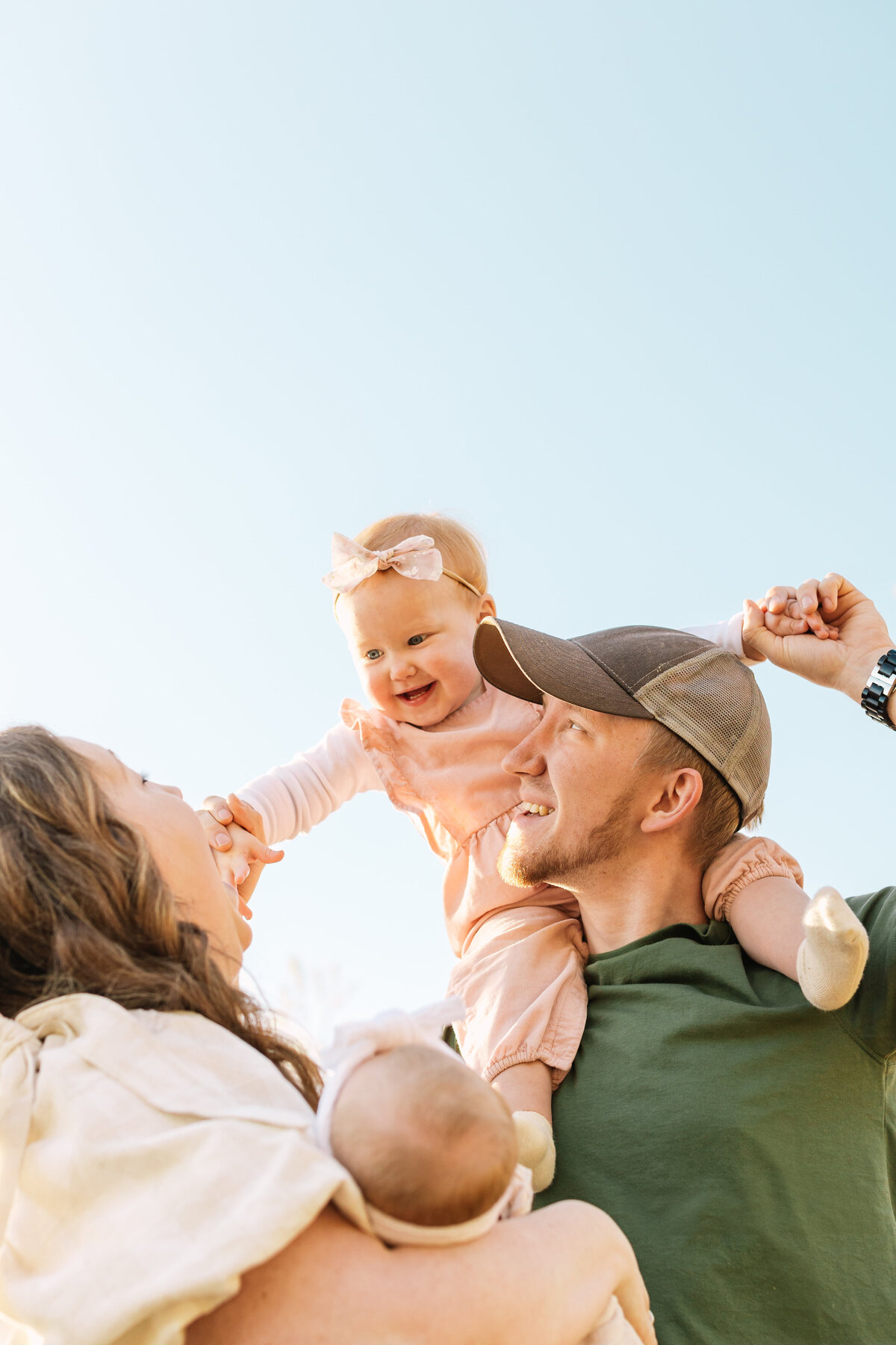 Asheville newborn photographer captures outdoor newborn session with mom, dad, a newborn baby girl and a toddler baby girl in Hendersonville, NC