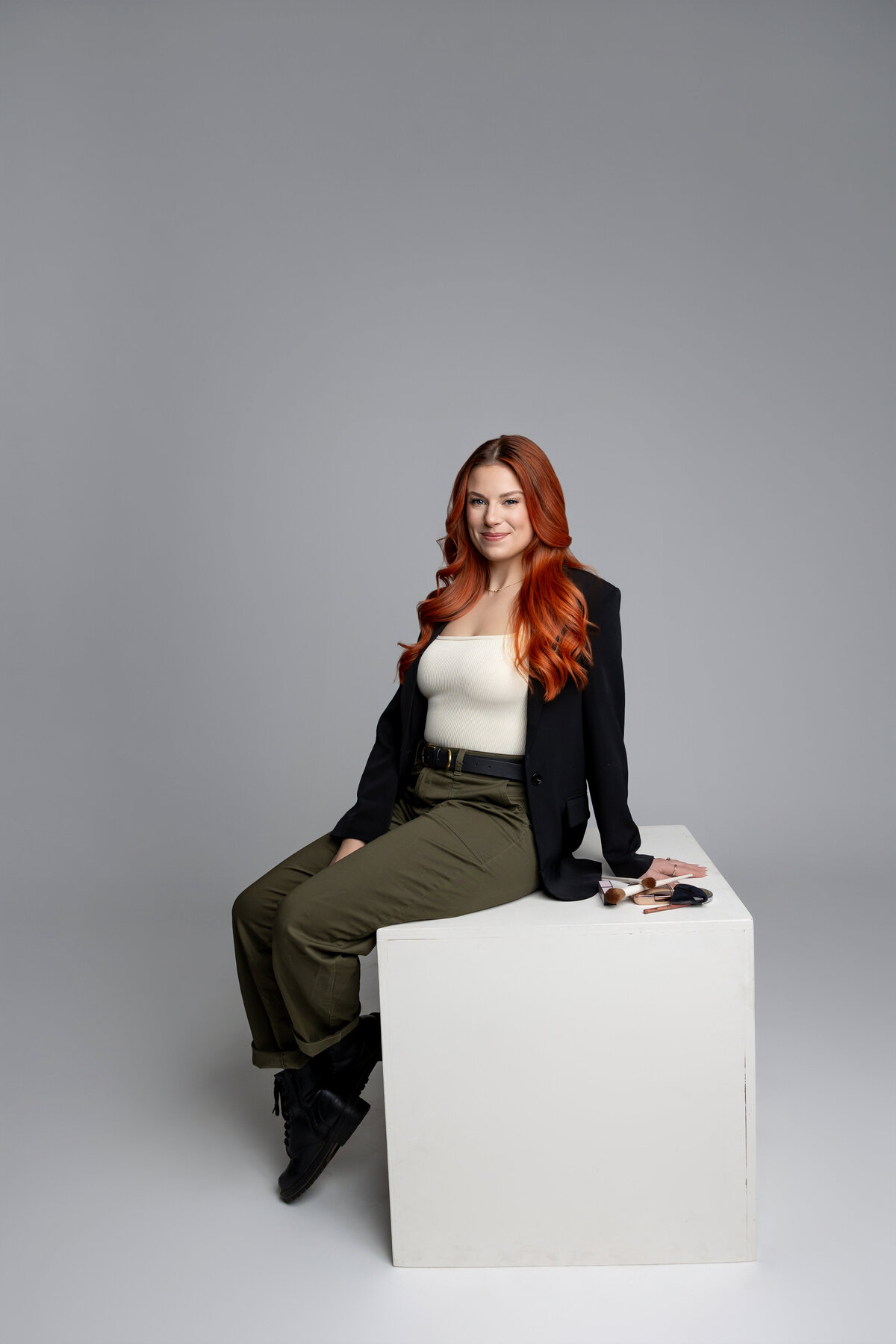 Professional branding portrait of red-haired woman seated with hands on lap. Photograph by Yucaipa branding photographer Kaitlyn Dawn Photography