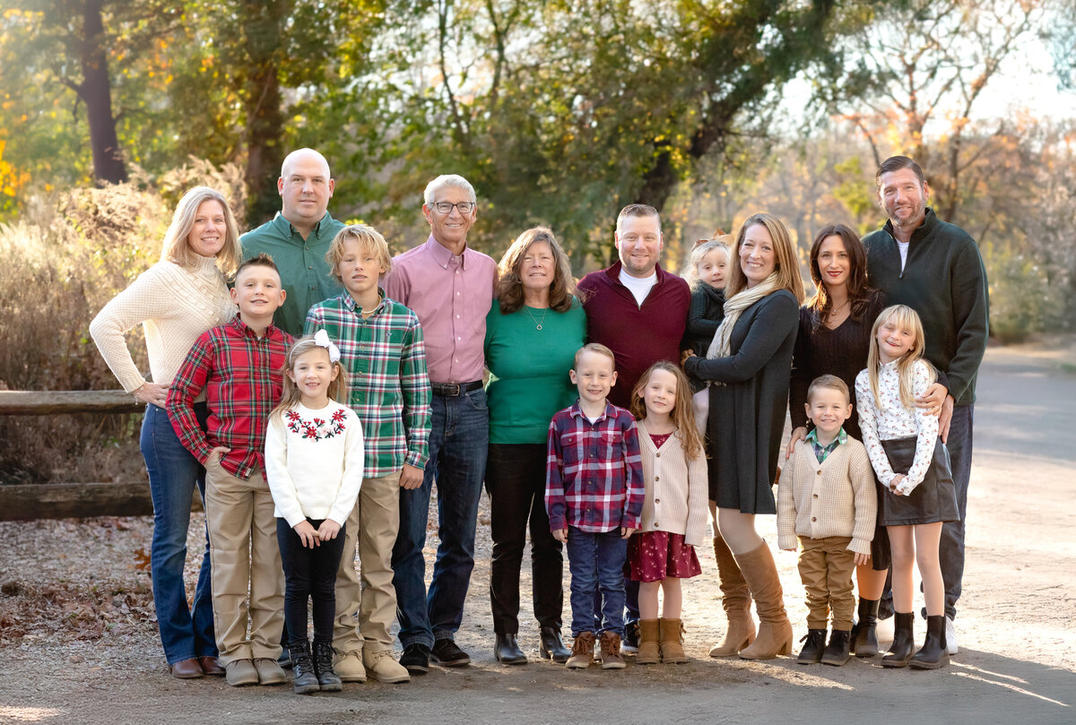extended family portrait on a path in a park