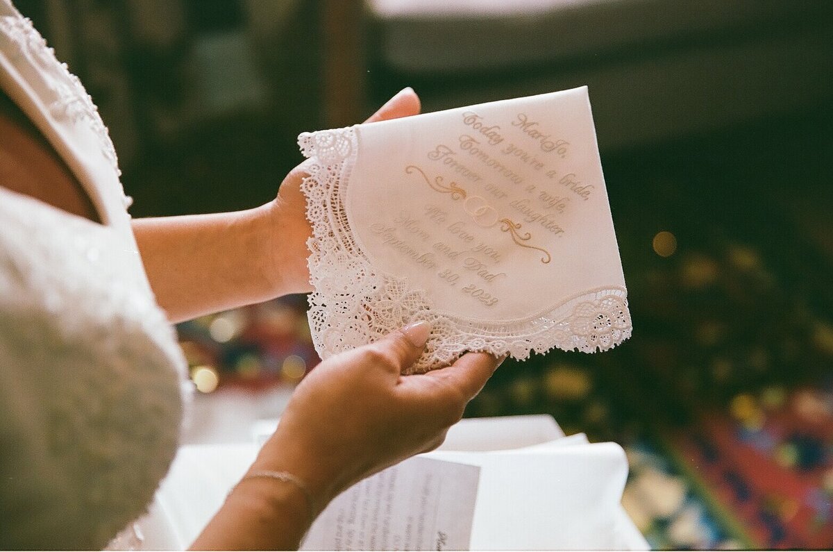 Groom fastening his shirt buttons before his wedding