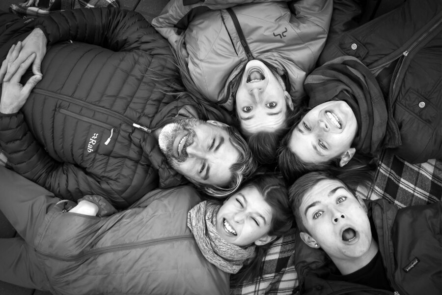 Black and white family with heads all together looking up.