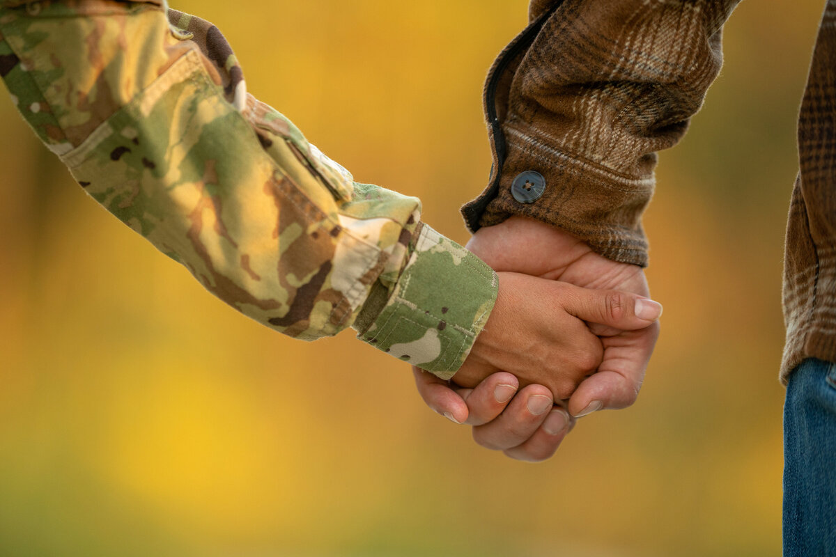 a picture of military family holding hands