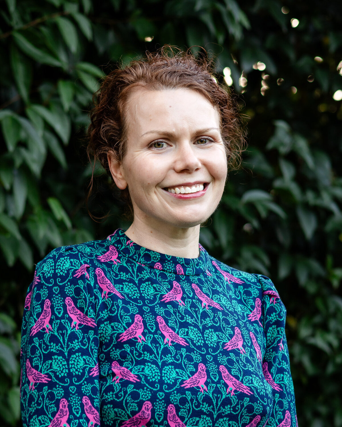 Natural light headshot of a smiling woman with braids for the Bay Area Headshot Portfolio taken outdoors – Ellobelle Photography
