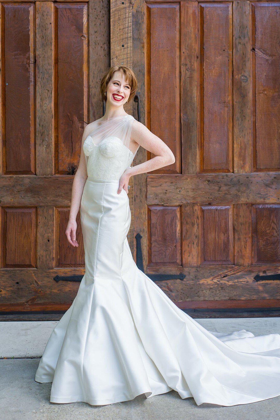 Natalia is a corset mermaid wedding dress with an asymmetric tulle bodice by bridal designer Edith Elan of Charleston, SC.