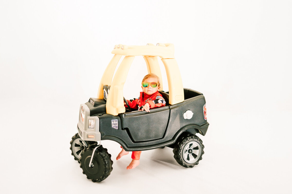 Springfield MO milestone photography of kid sitting in little tike truck