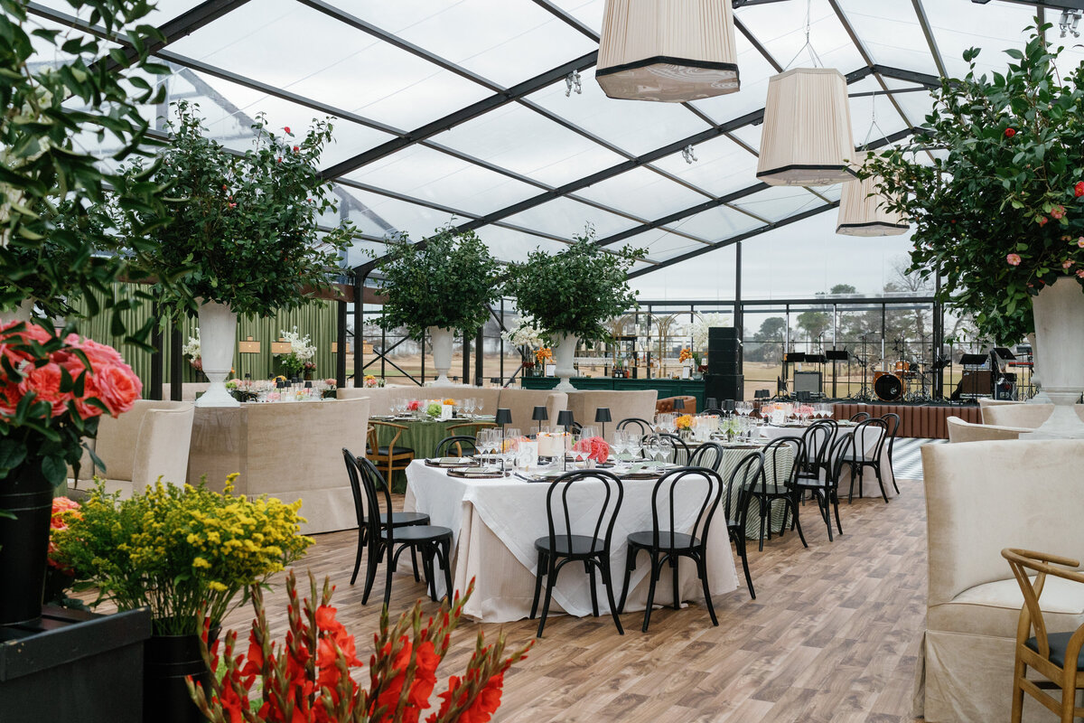 Tented wedding reception at Brook Hollow Golf Club with large trees